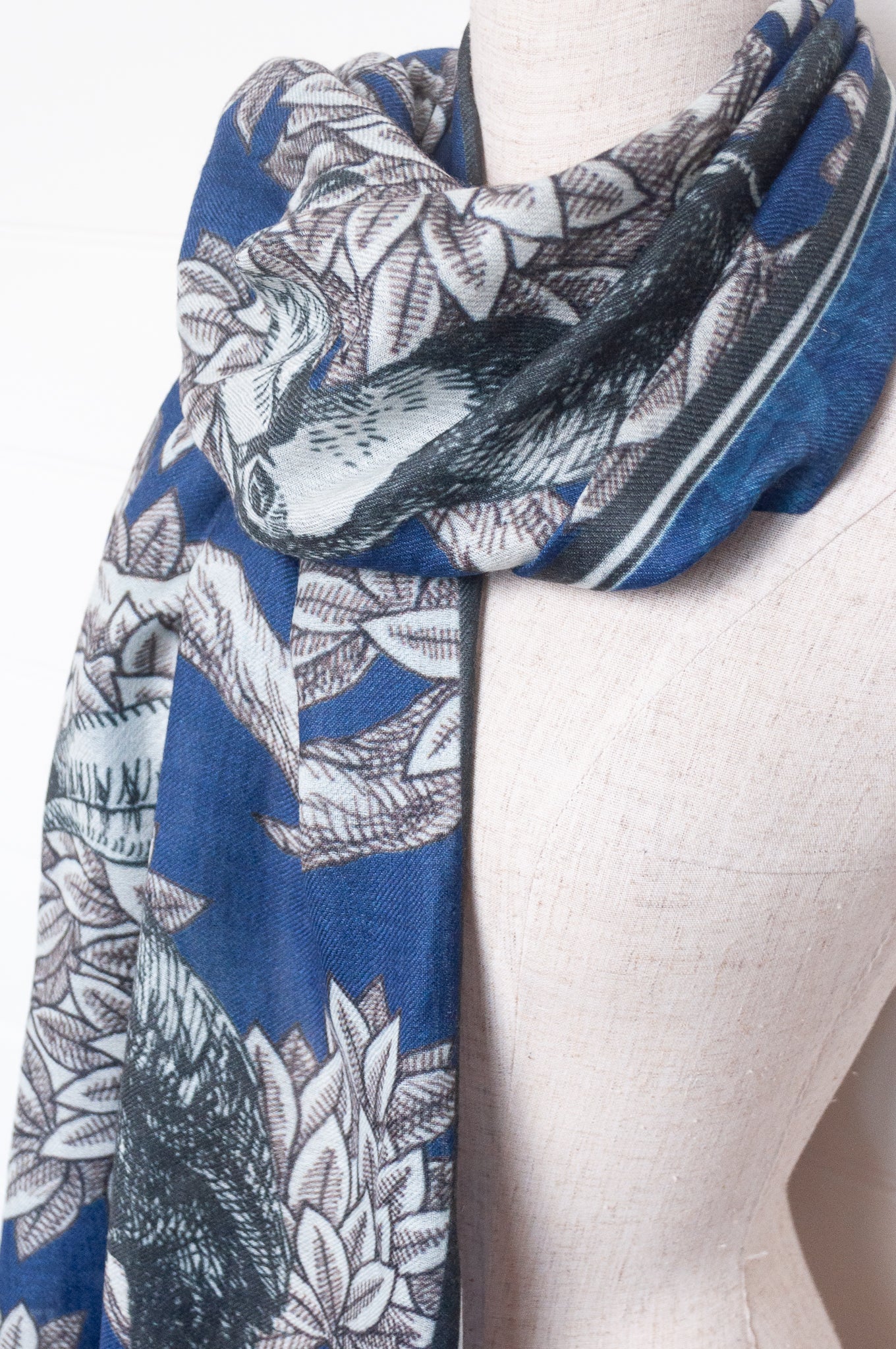 Blue floral patterned scarf on a white background