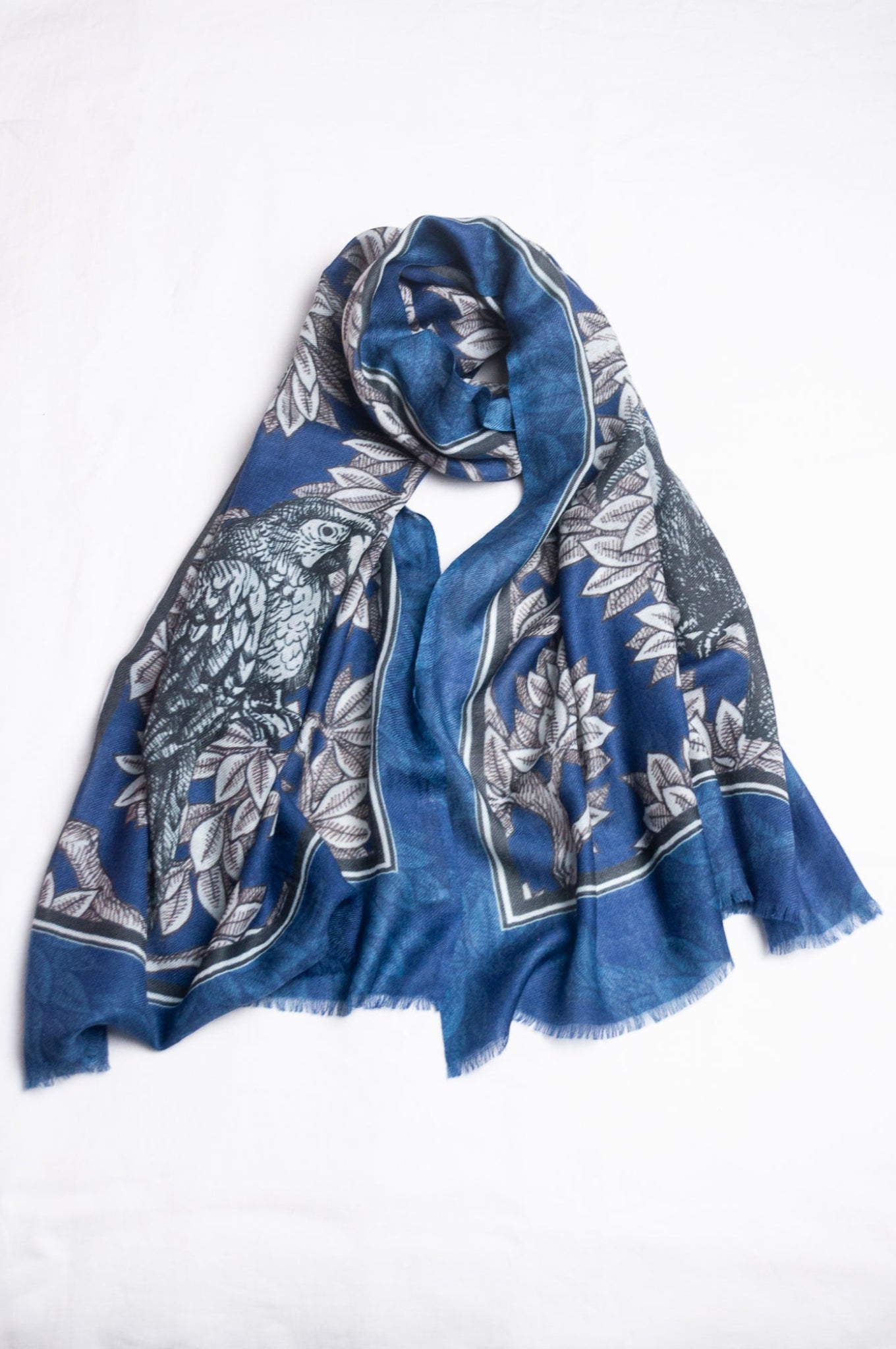 Blue floral patterned scarf on a white background