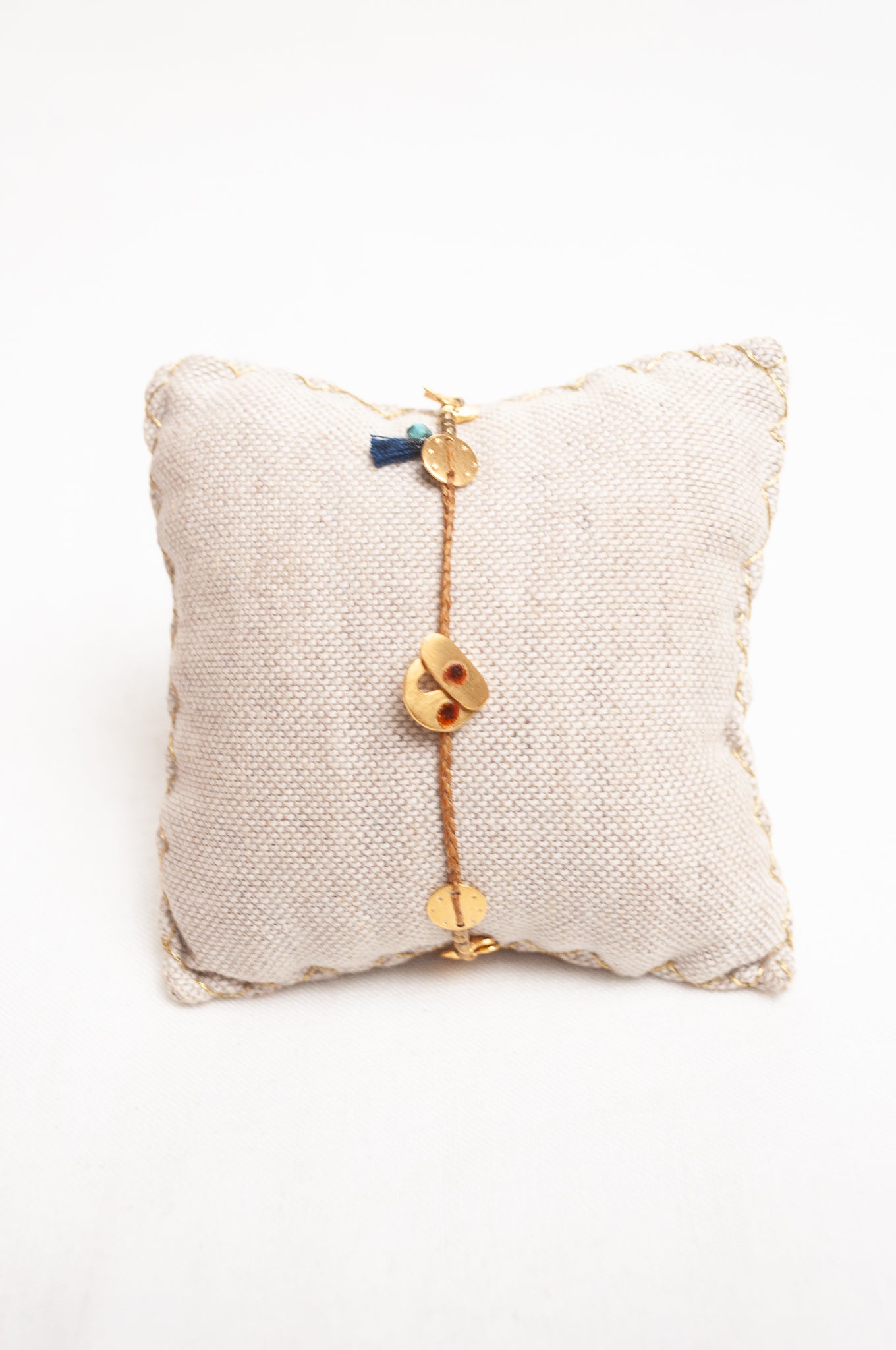 Mary Gaitani made in Greece waxed cord bracelet with gold charms and tiny tassel.