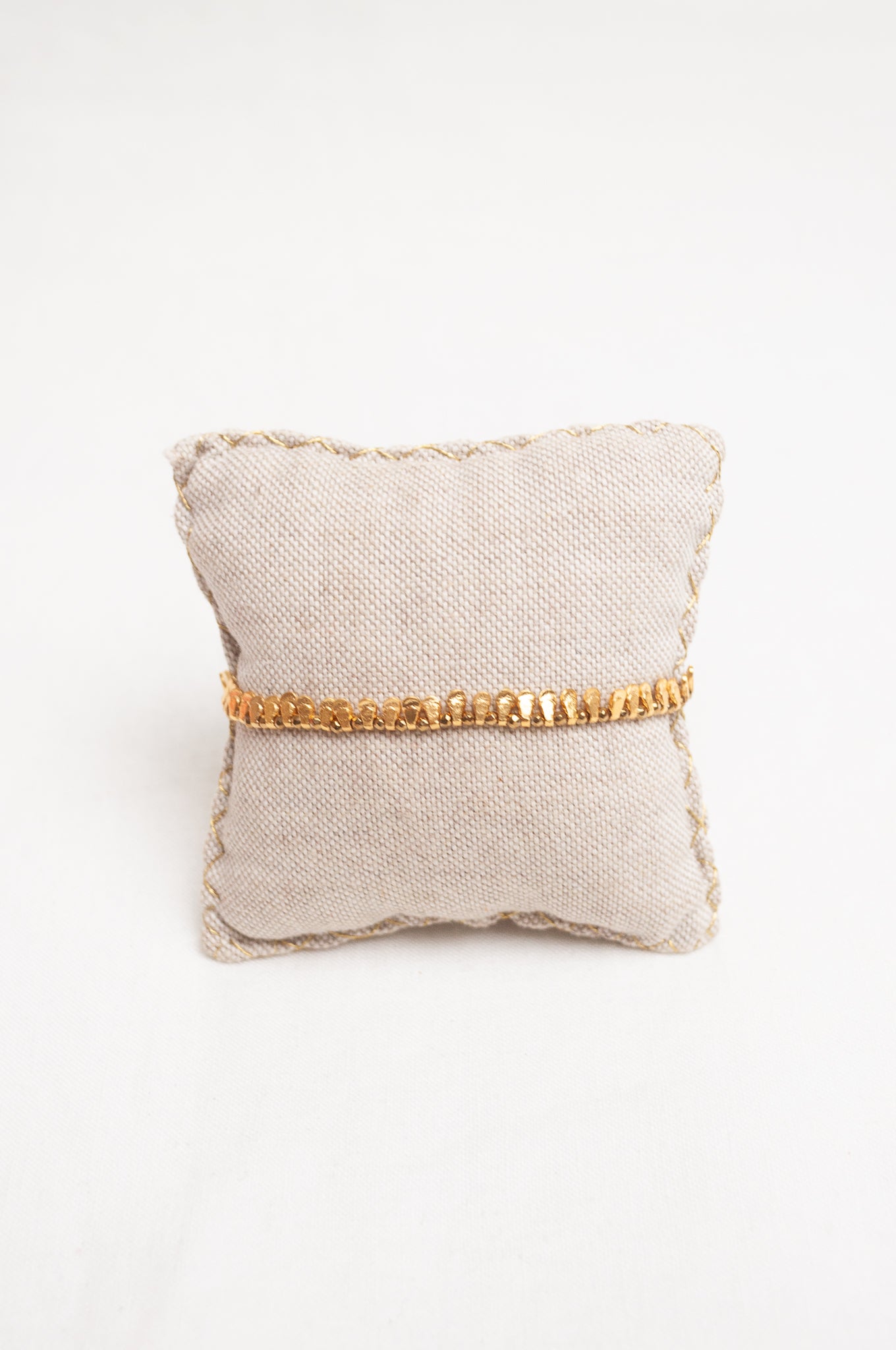 Mary Gaitani made in Greece waxed cord bracelet with gold charms and tiny tassel.