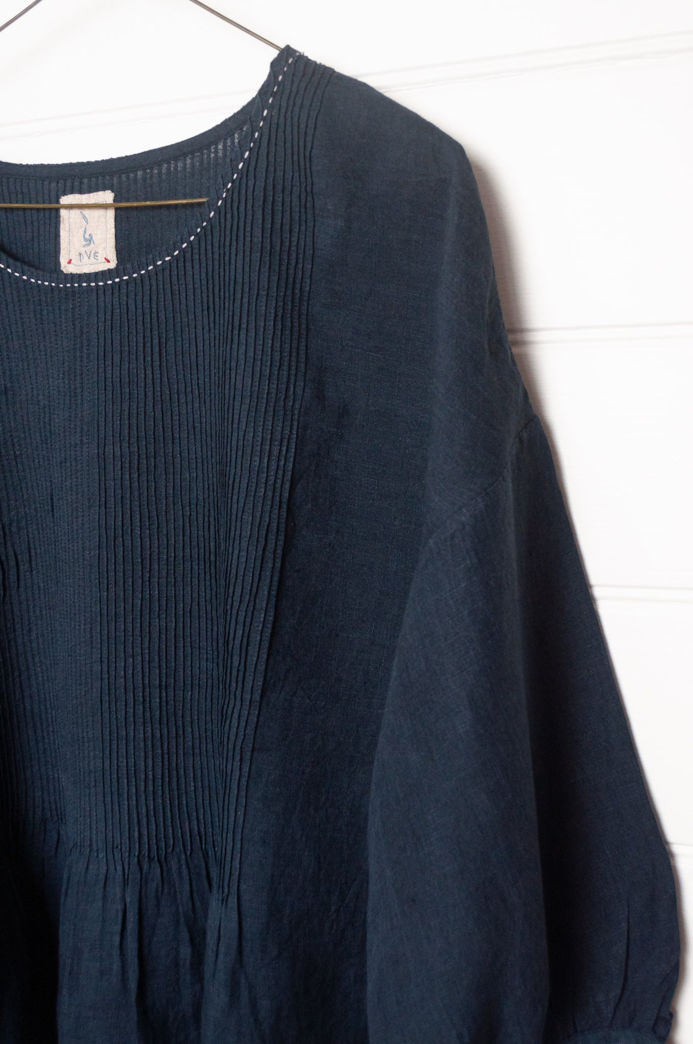 DVE Anisha pintucked top in navy linen with white striped selvedege details.