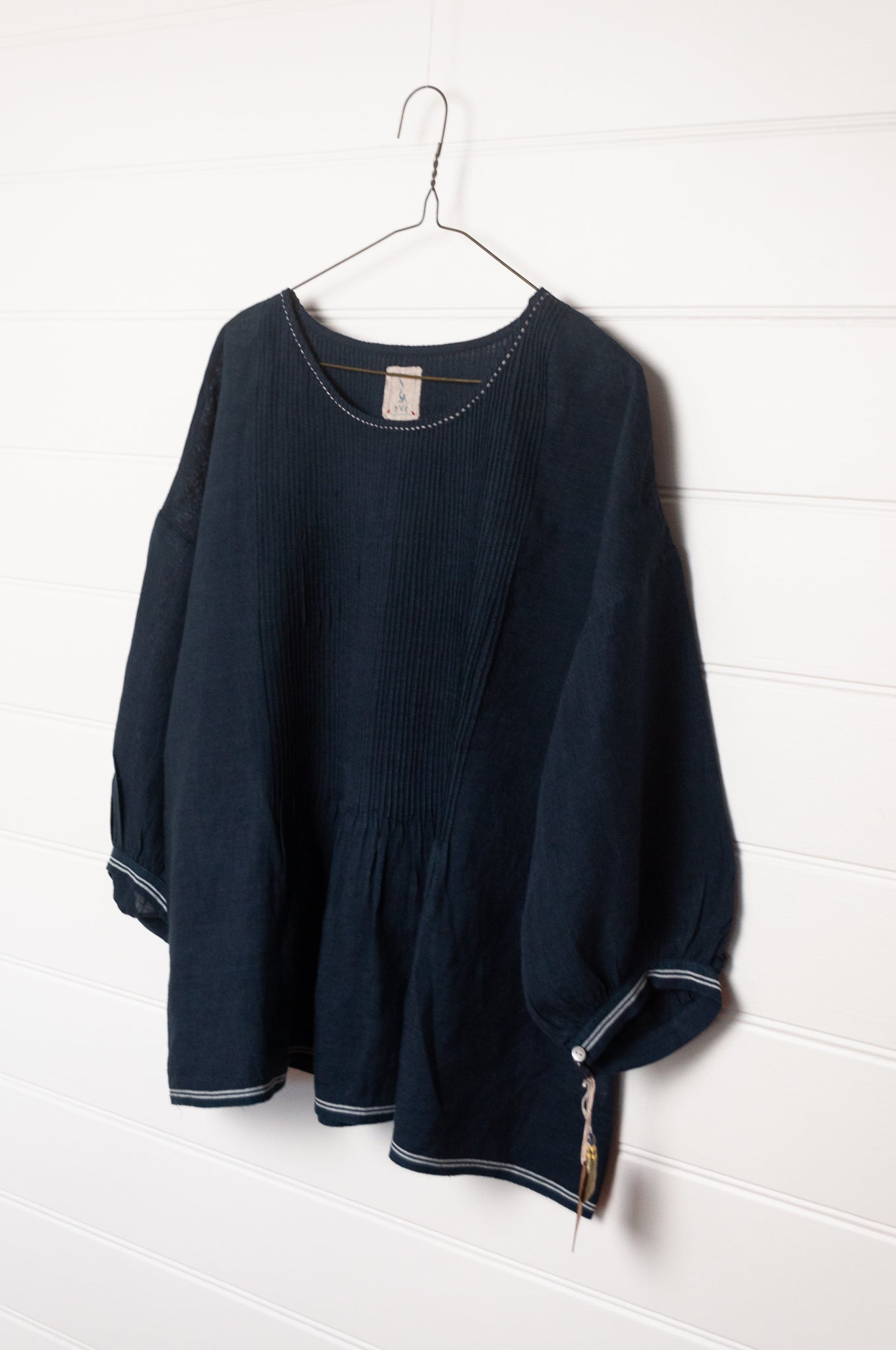 DVE Anisha pintucked top in navy linen with white striped selvedege details.