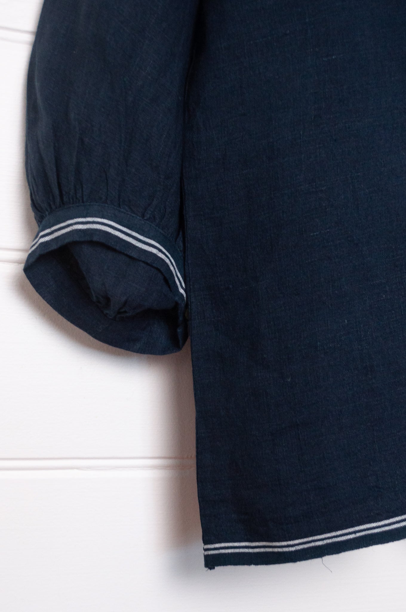 DVE Anisha pintucked top in navy linen with white striped selvedege details.