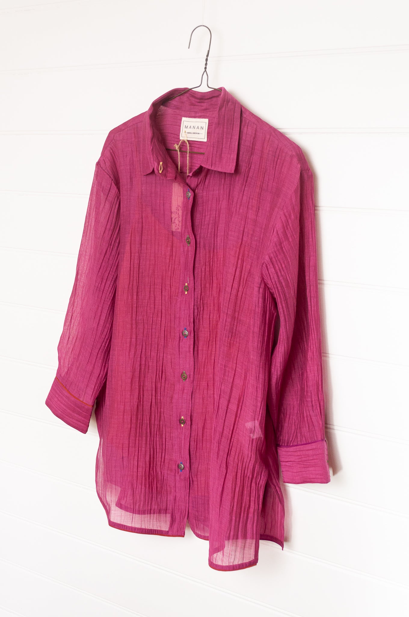 Manan lightweight cotton silk long sleeve button up shirt in magenta pink with orange silk camisole.