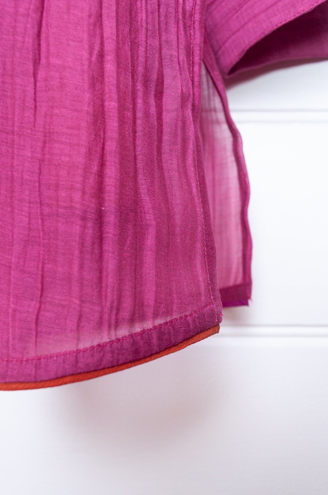 Manan lightweight cotton silk long sleeve button up shirt in magenta pink with orange silk camisole.