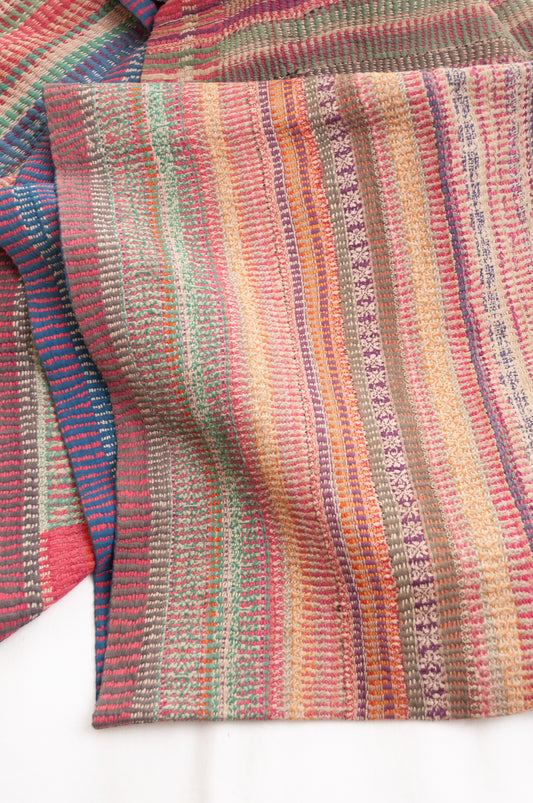 Vintage kantha quilt in deep pink, blue and green, and floral braid stripes.
