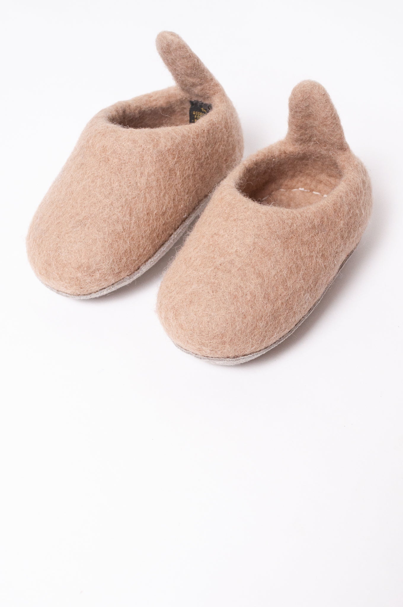 Wool felt baby slippers in oat beige.