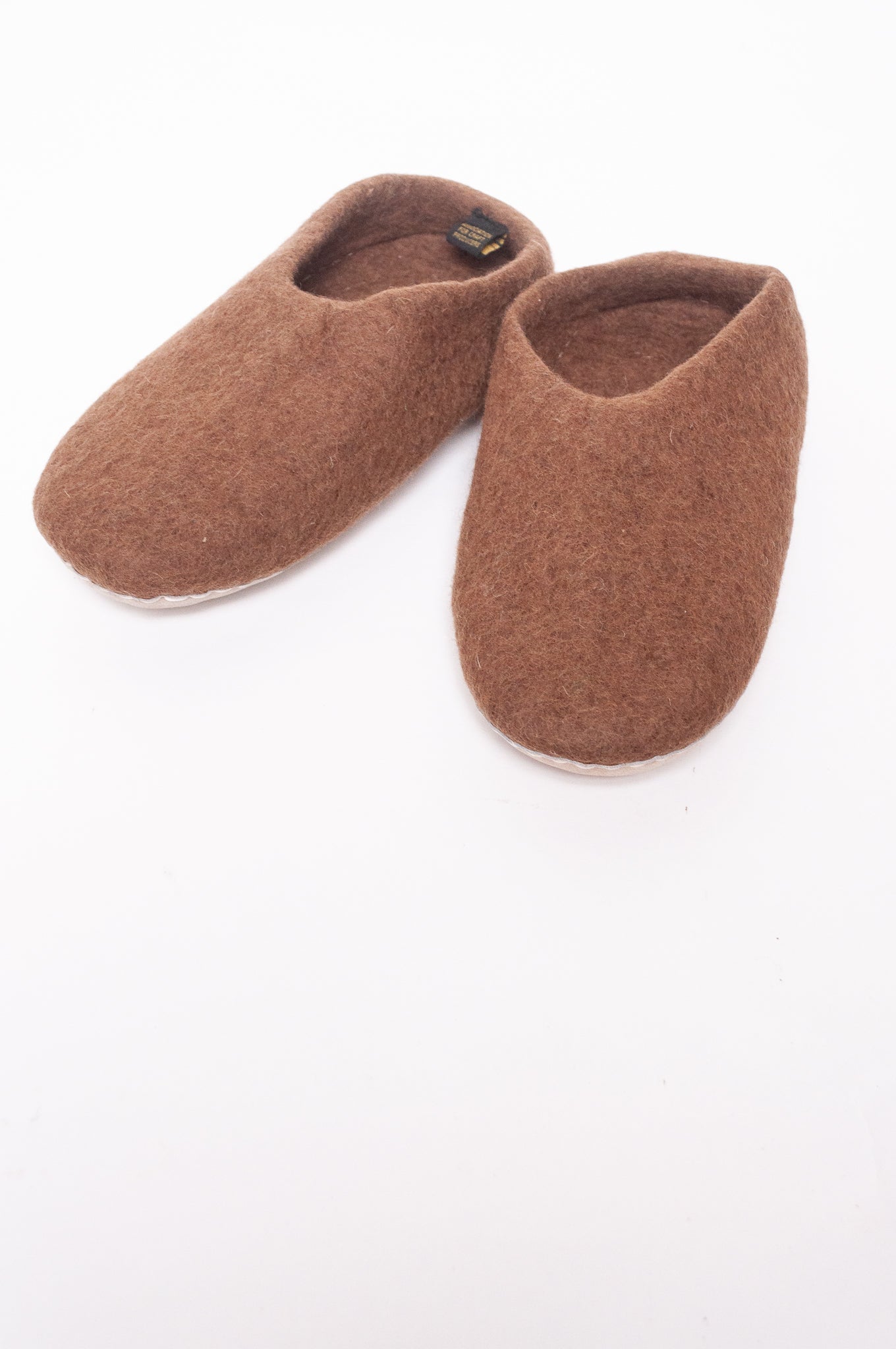Wool felt slip on slippers in brown.