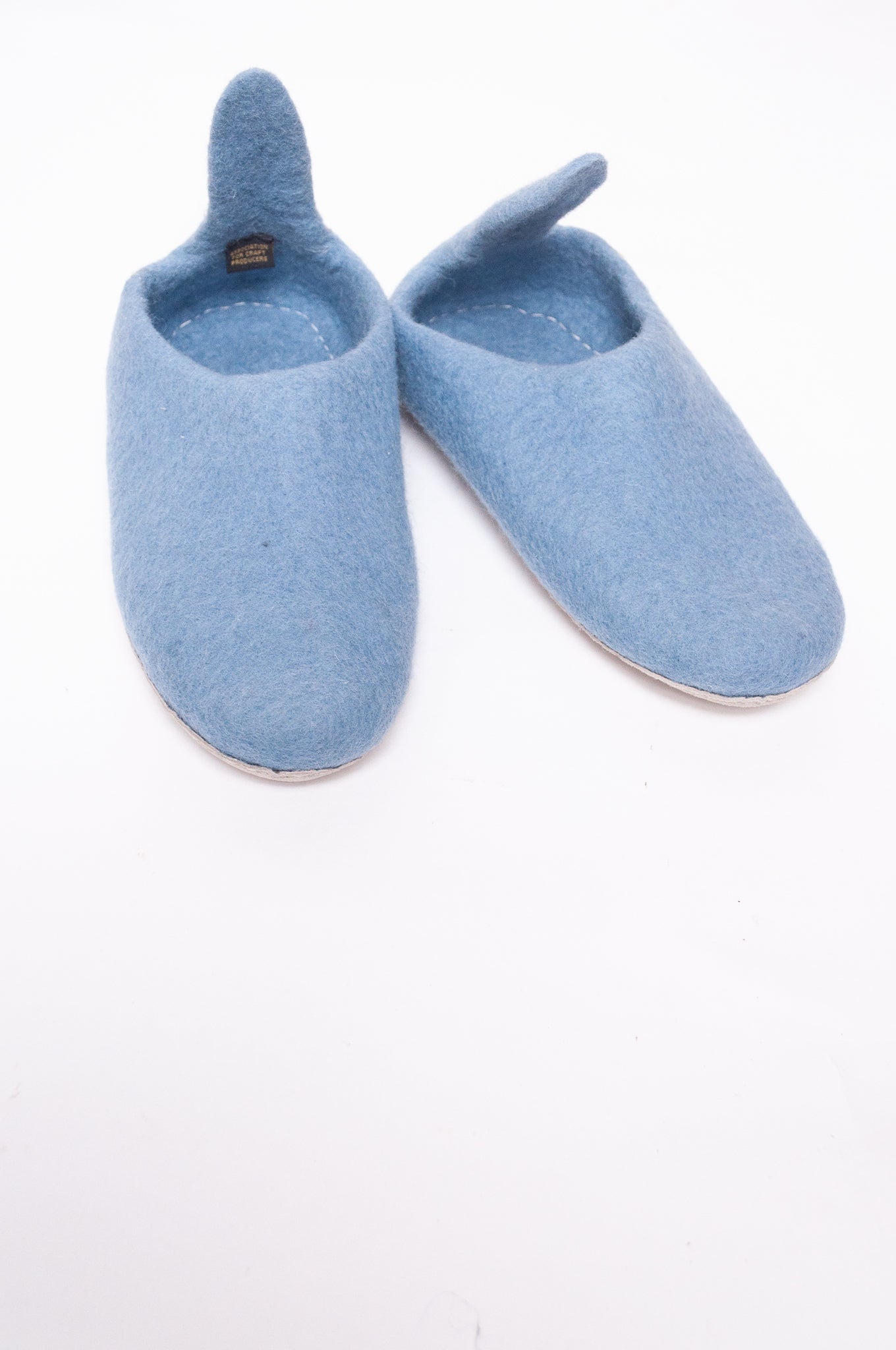 Wool felt pull on slippers in baby blue.