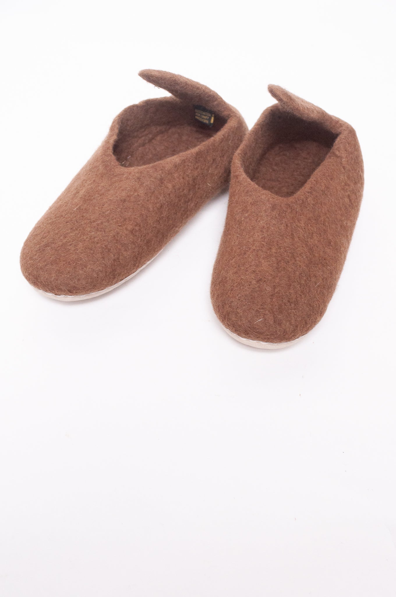 Wool felt pull on slippers in brown.