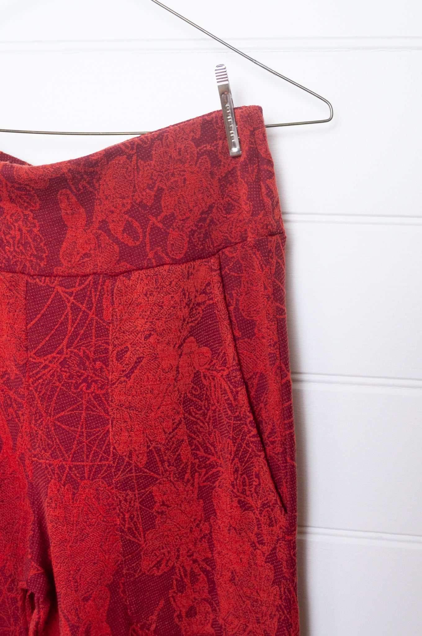Valia travel pant pull on wool jersey knit in jacquard print Oxblood red  pocket close up.