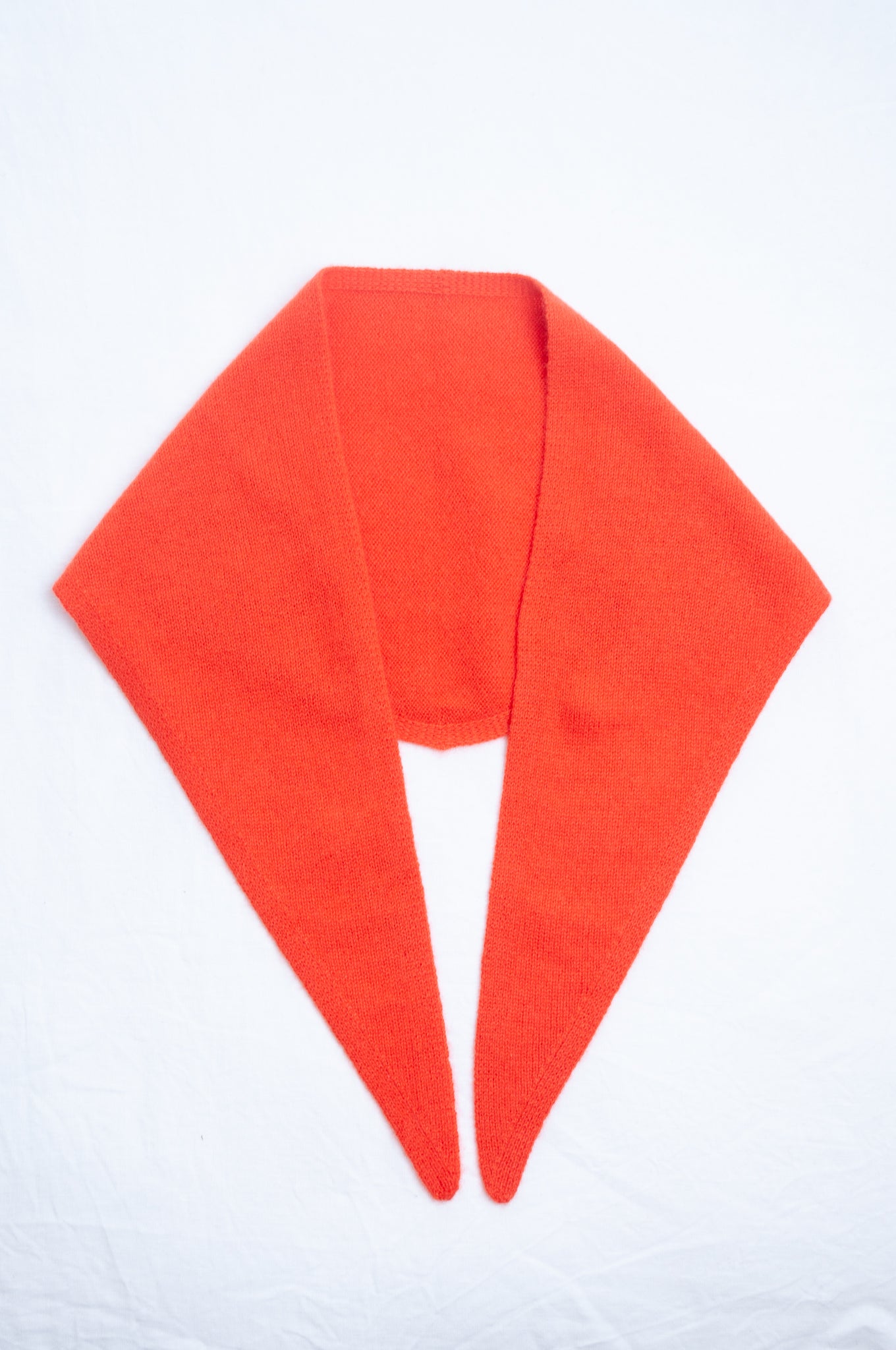 Cashmere triangle neck scarf in tangerine red orange.