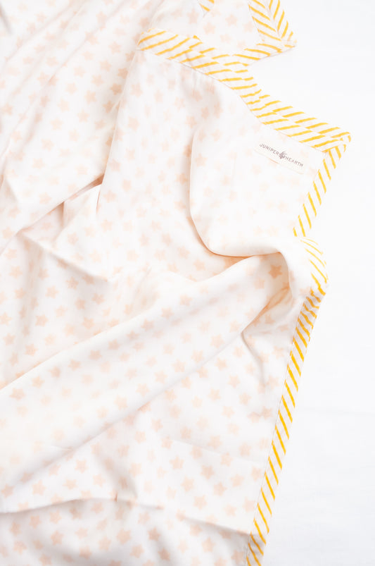 Baby dohar cot size cotton muslin block print yellow stars on white.