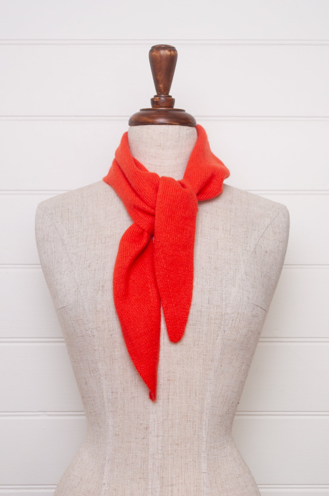 Cashmere triangle neck scarf in tangerine red orange.