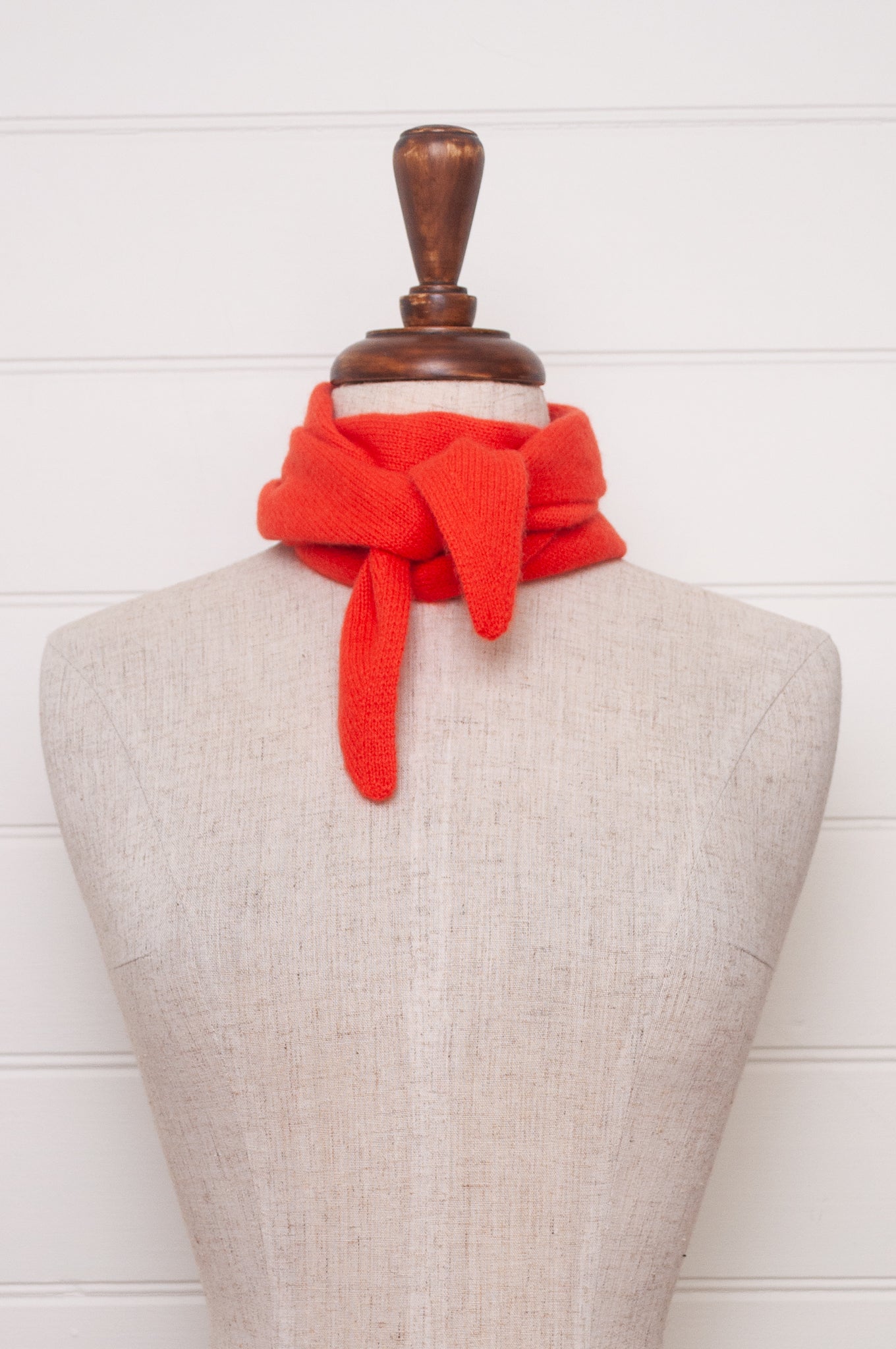 Cashmere triangle neck scarf in tangerine red orange.