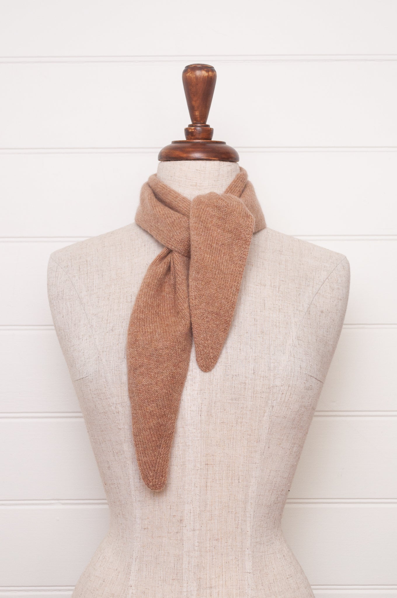 Cashmere triangle neck scarf in camel light tan brown.