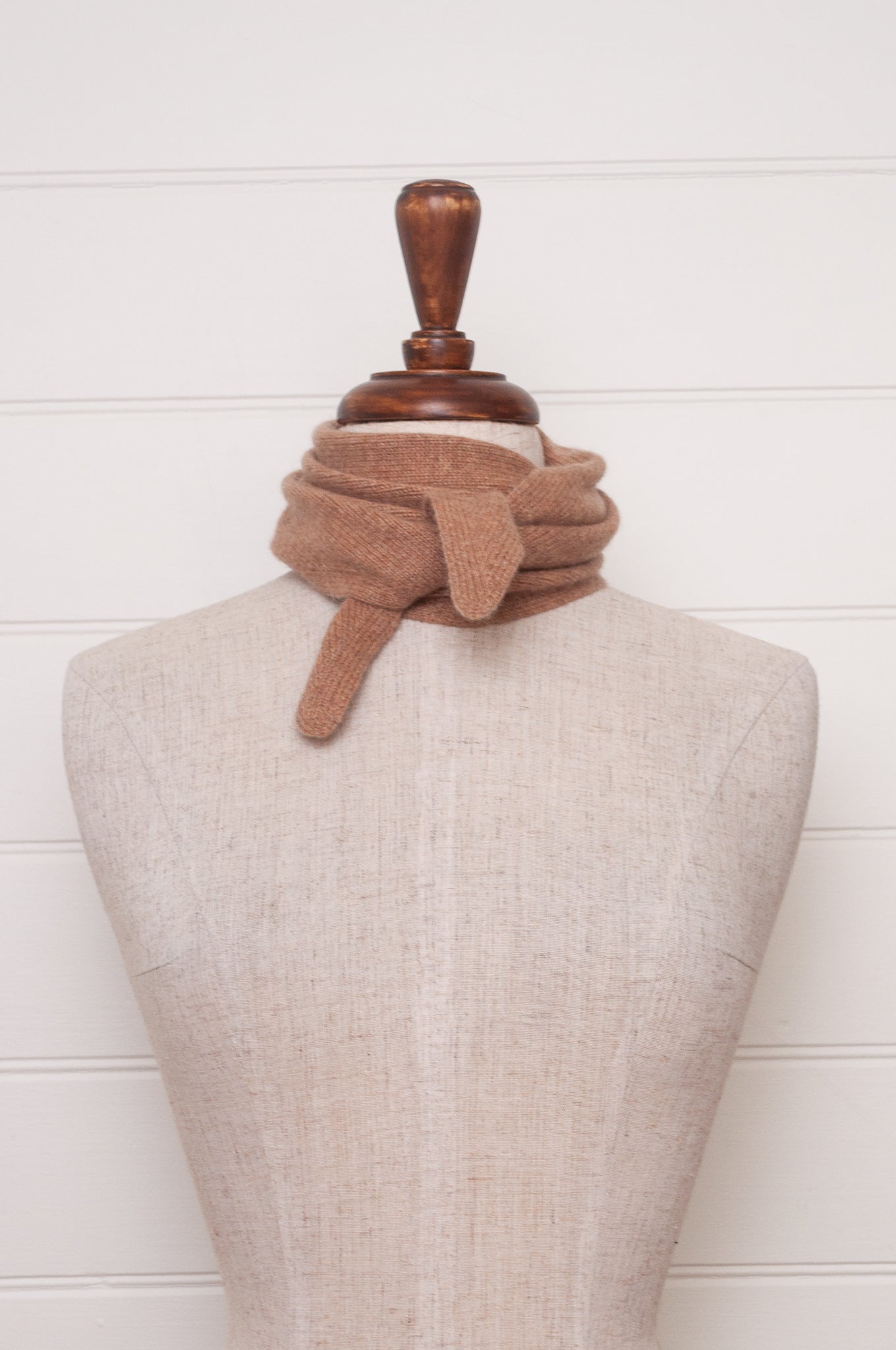 Cashmere triangle neck scarf in camel light tan brown.