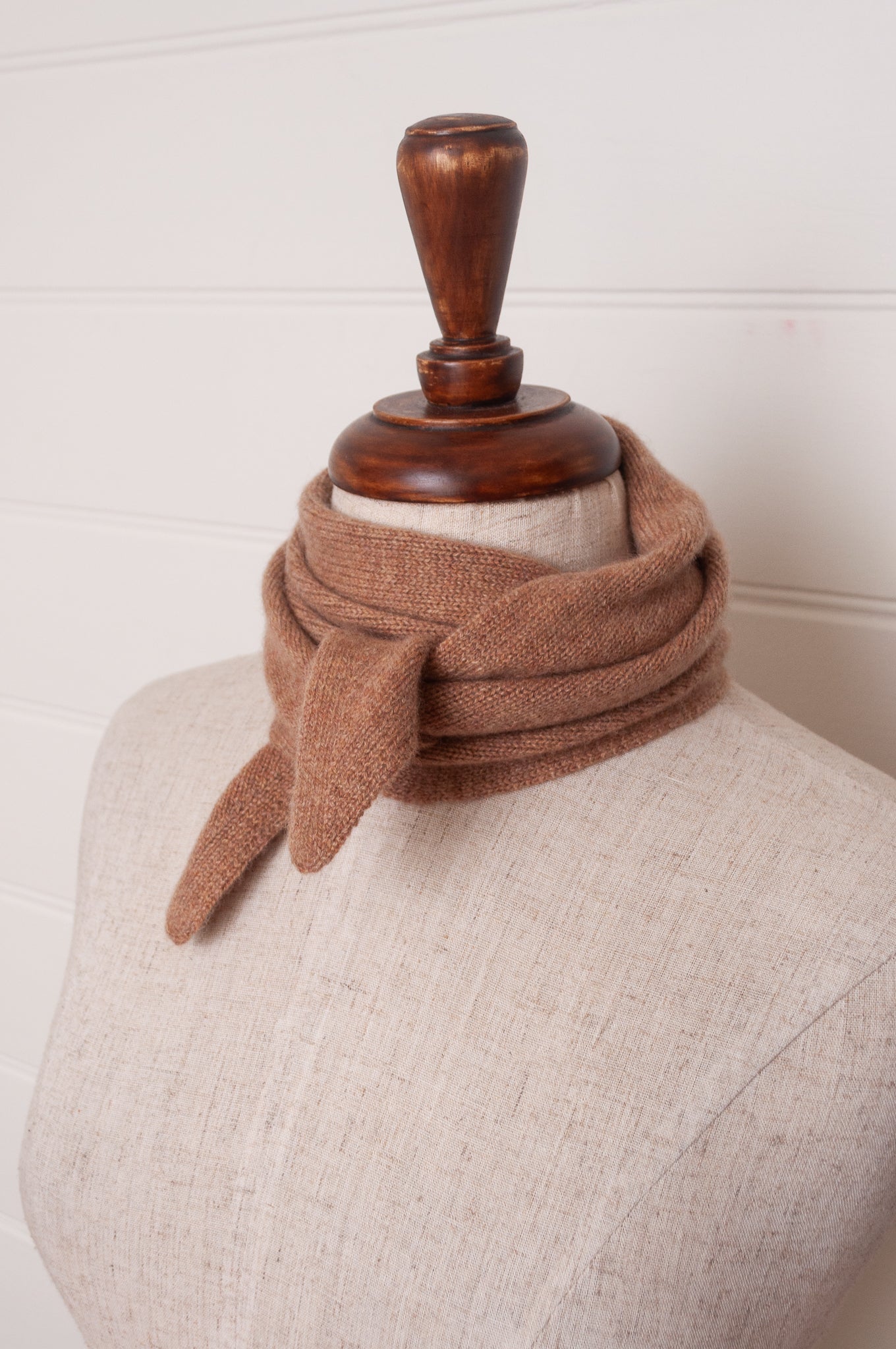 Cashmere triangle neck scarf in camel light tan brown.