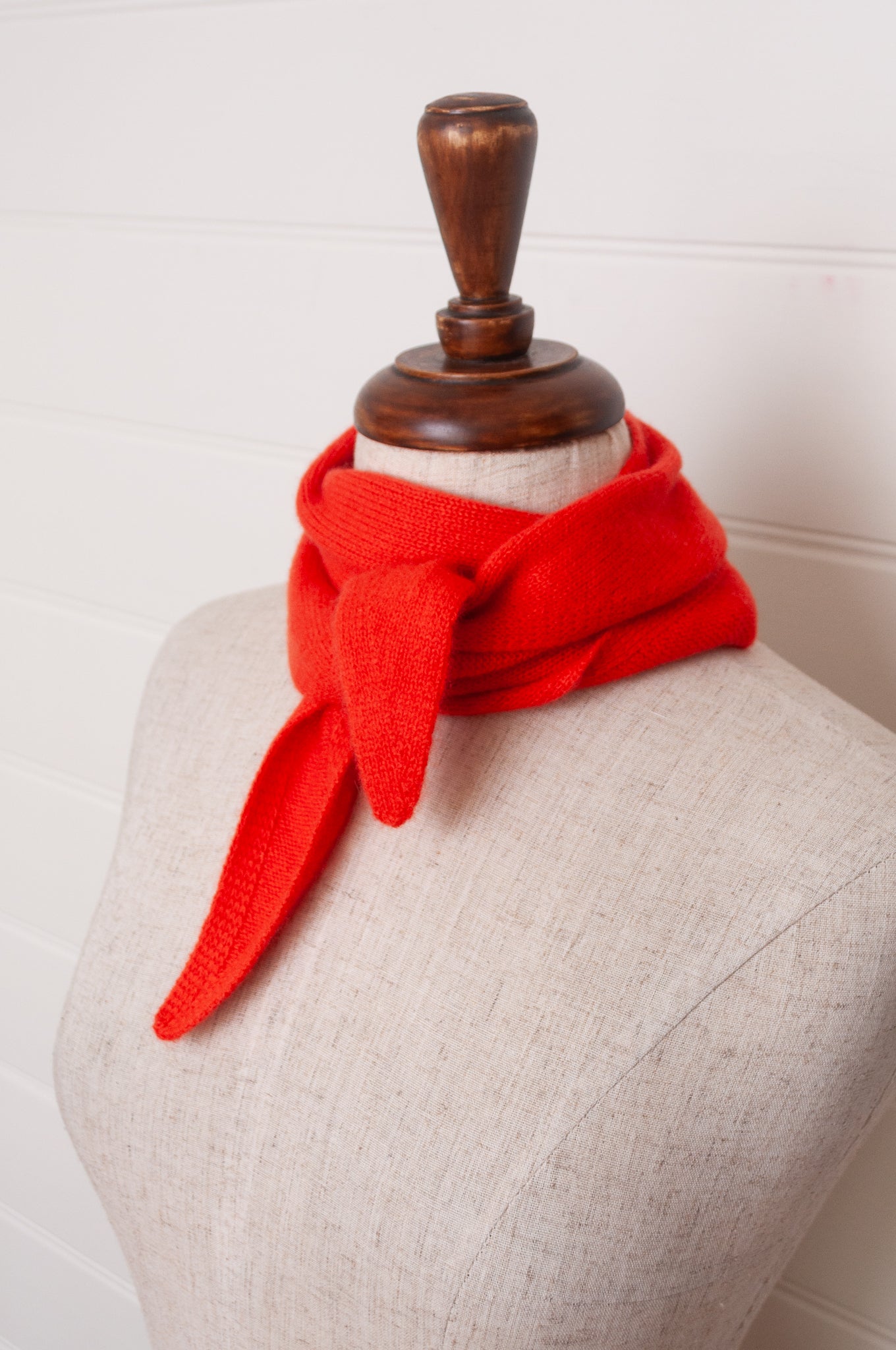 Cashmere triangle neck scarf in tangerine red orange.