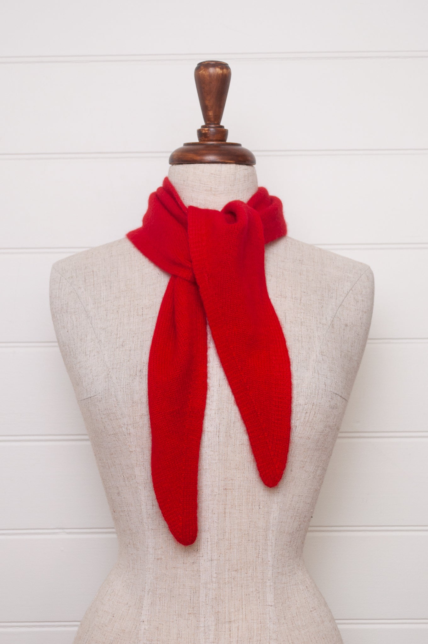 Cashmere triangle neck scarf in tangerine red orange.