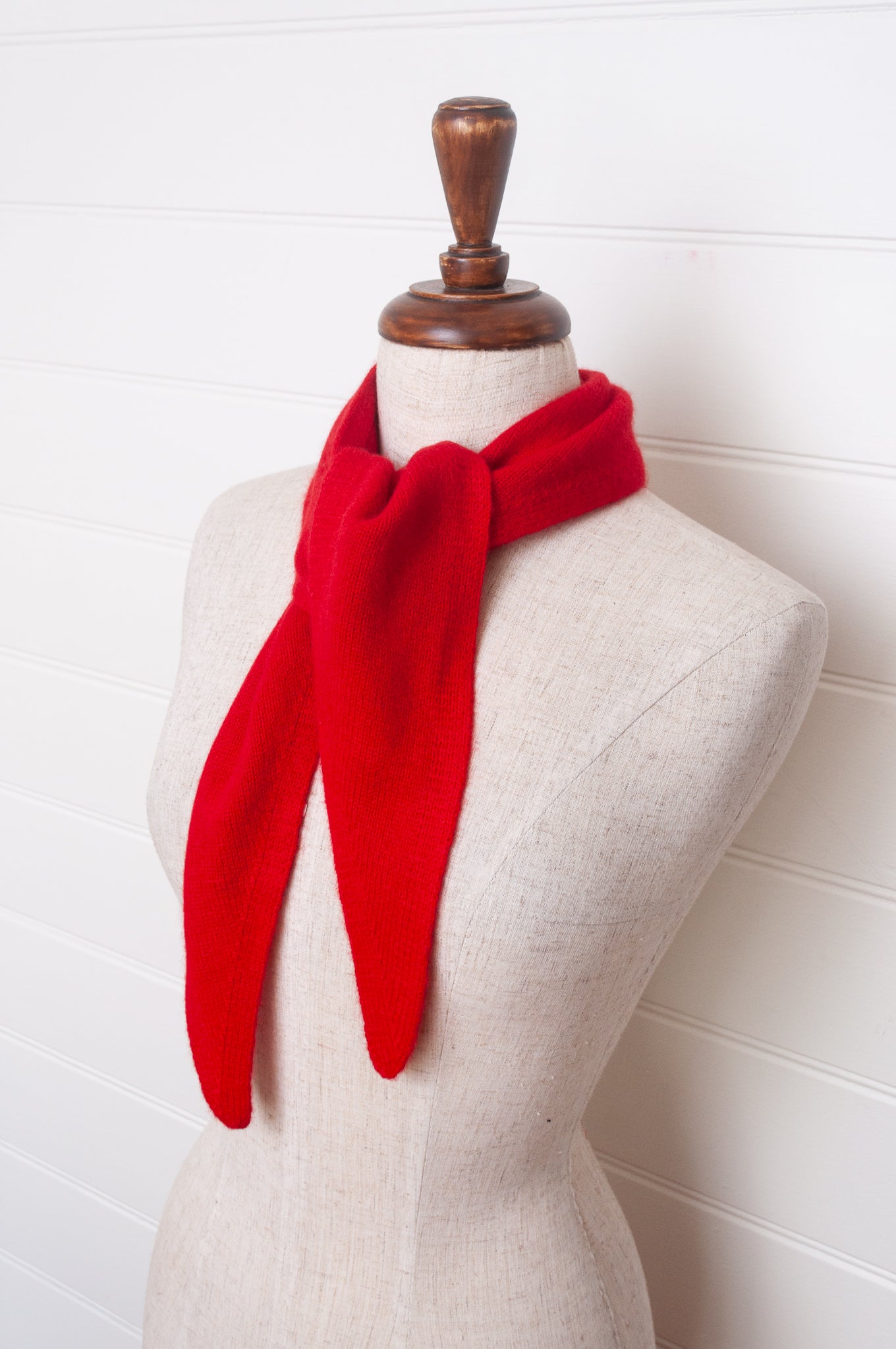 Cashmere triangle neck scarf in tangerine red orange.