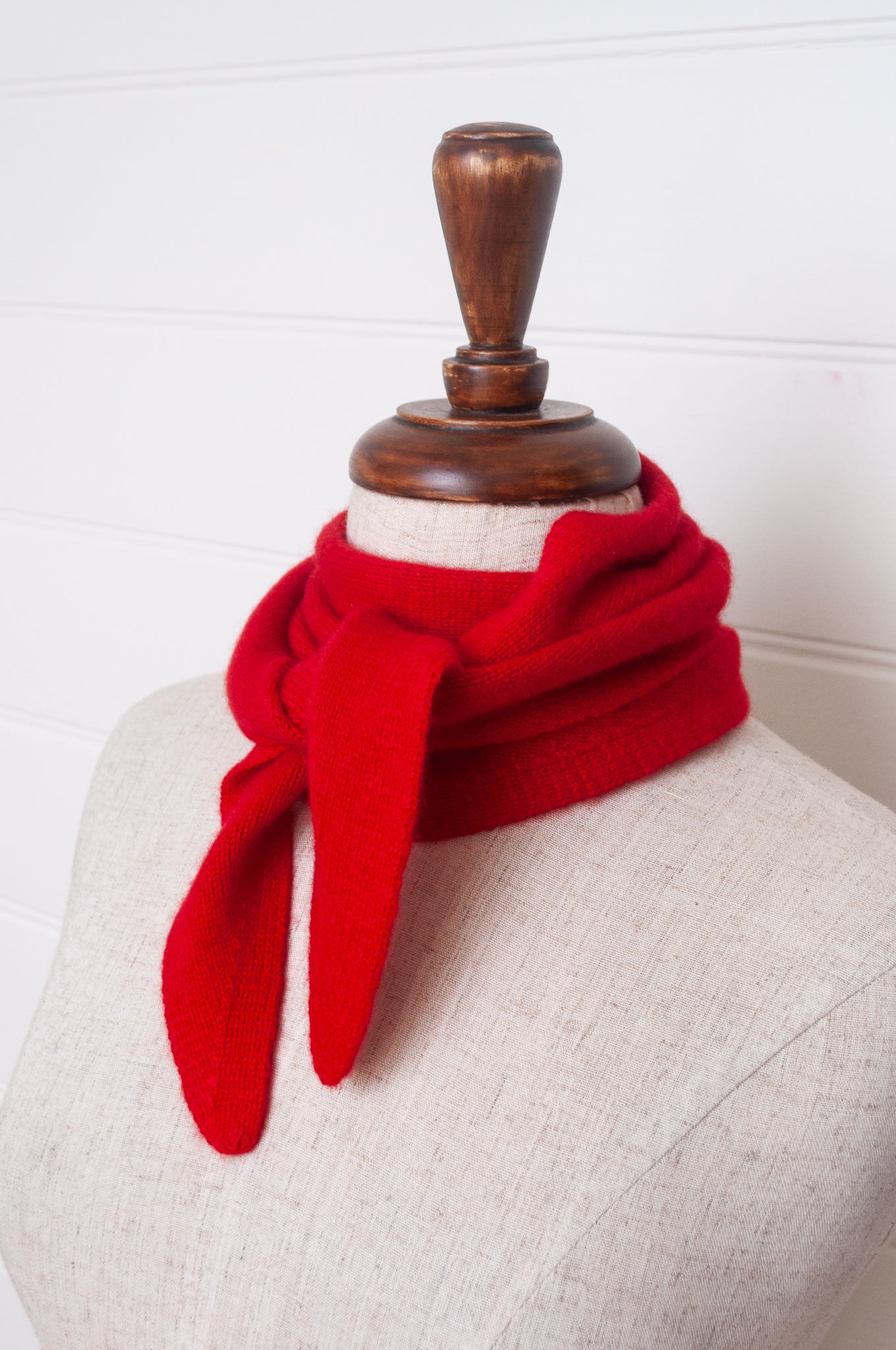 Cashmere triangle neck scarf in tangerine red orange.
