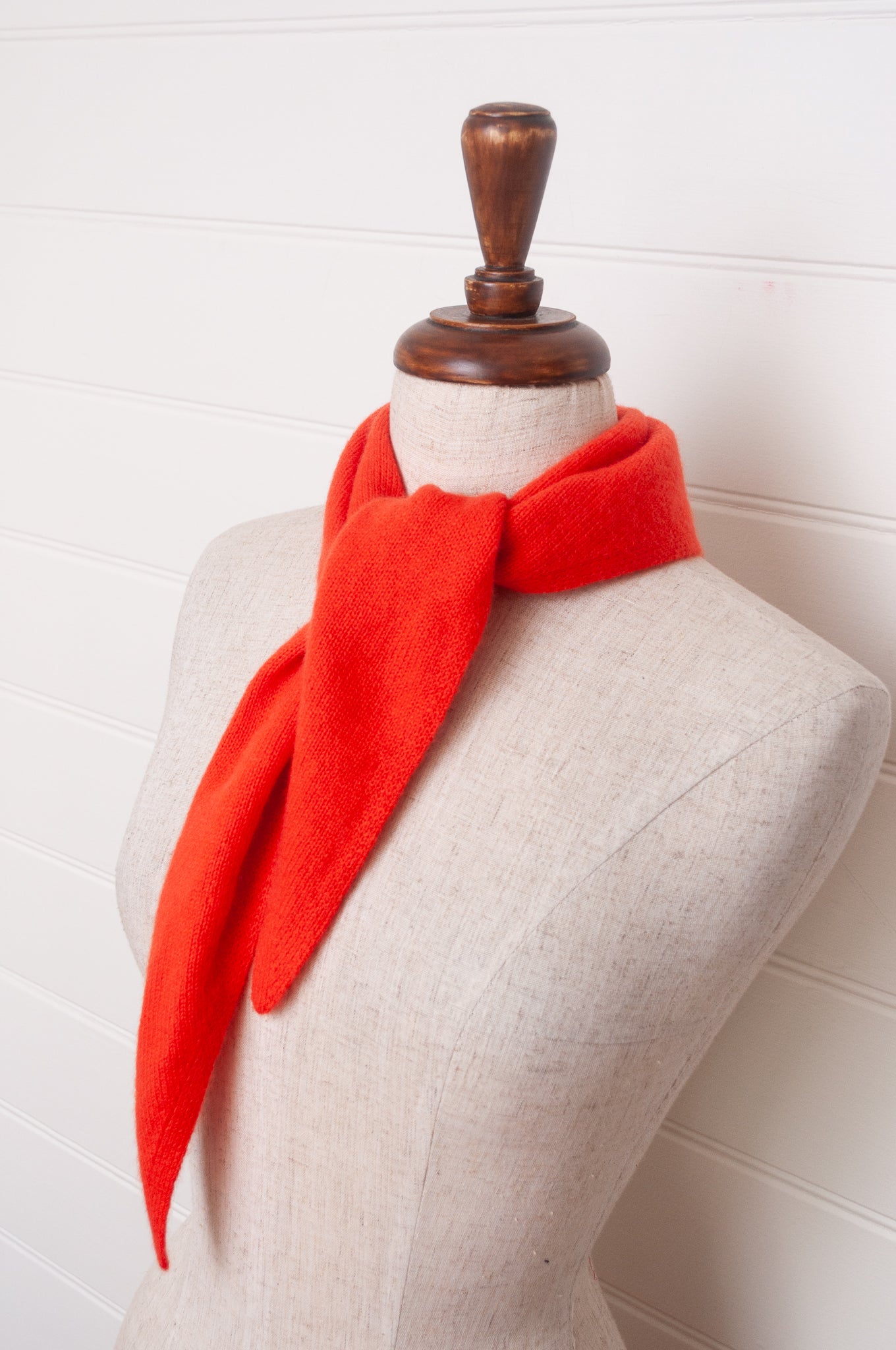Cashmere triangle neck scarf in tangerine red orange.