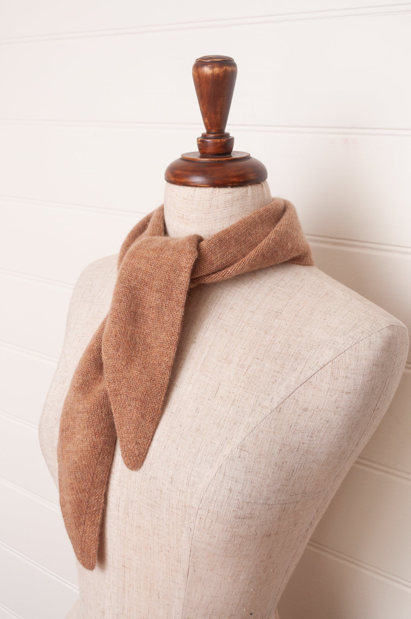 Cashmere triangle neck scarf in camel light tan brown.