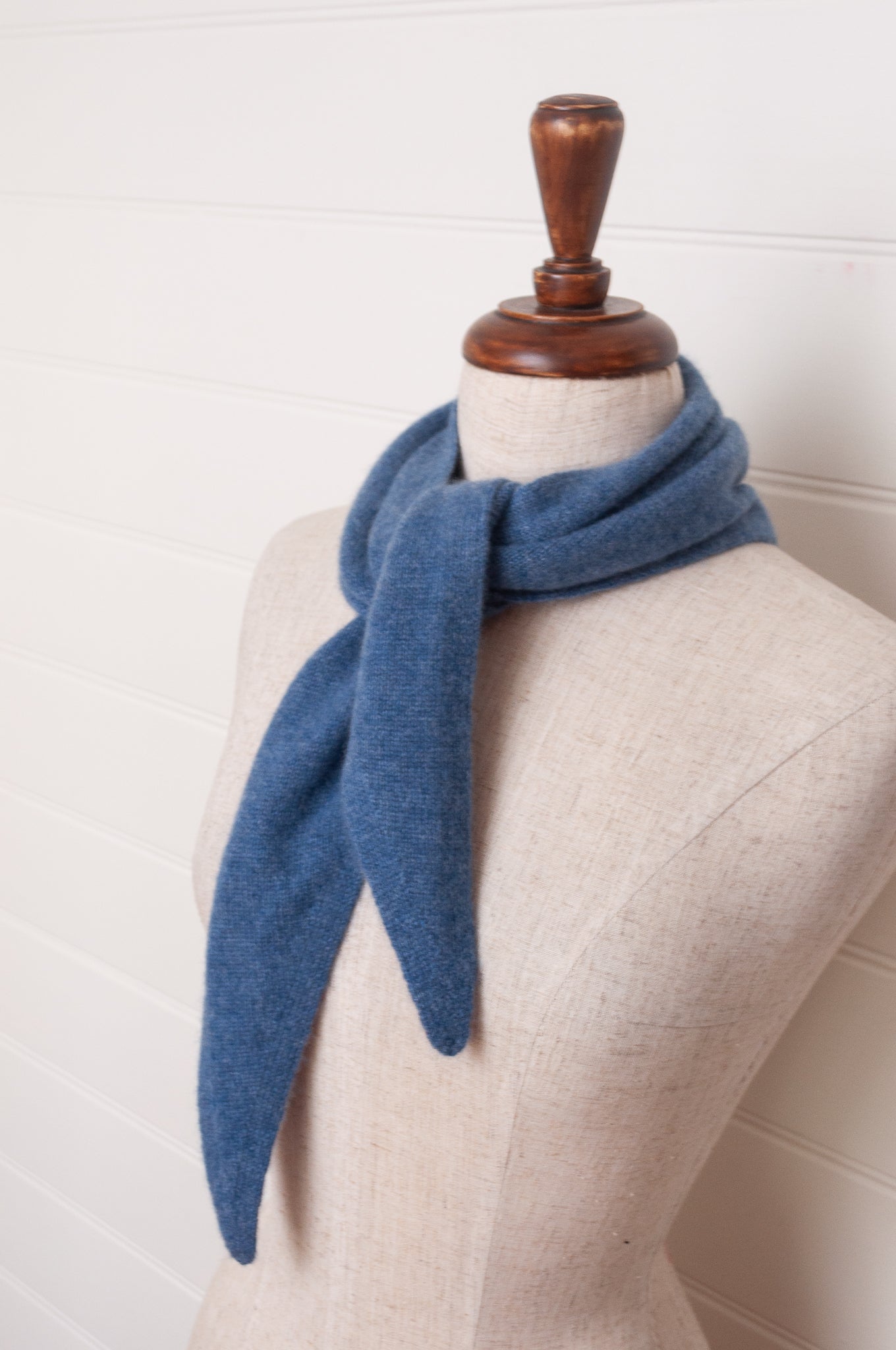 Cashmere triangle neck scarf in denim blue.