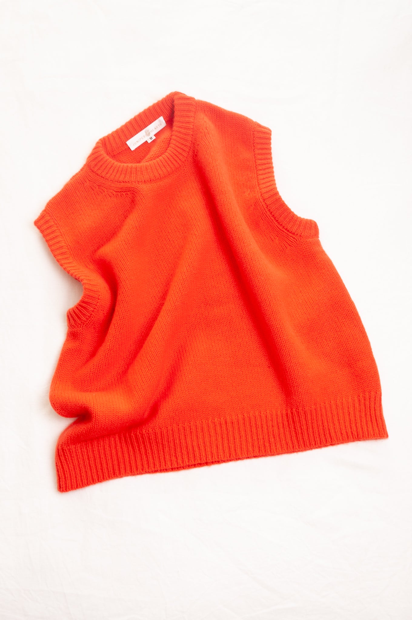Cashmere round neck vest in tangerine orange red.
