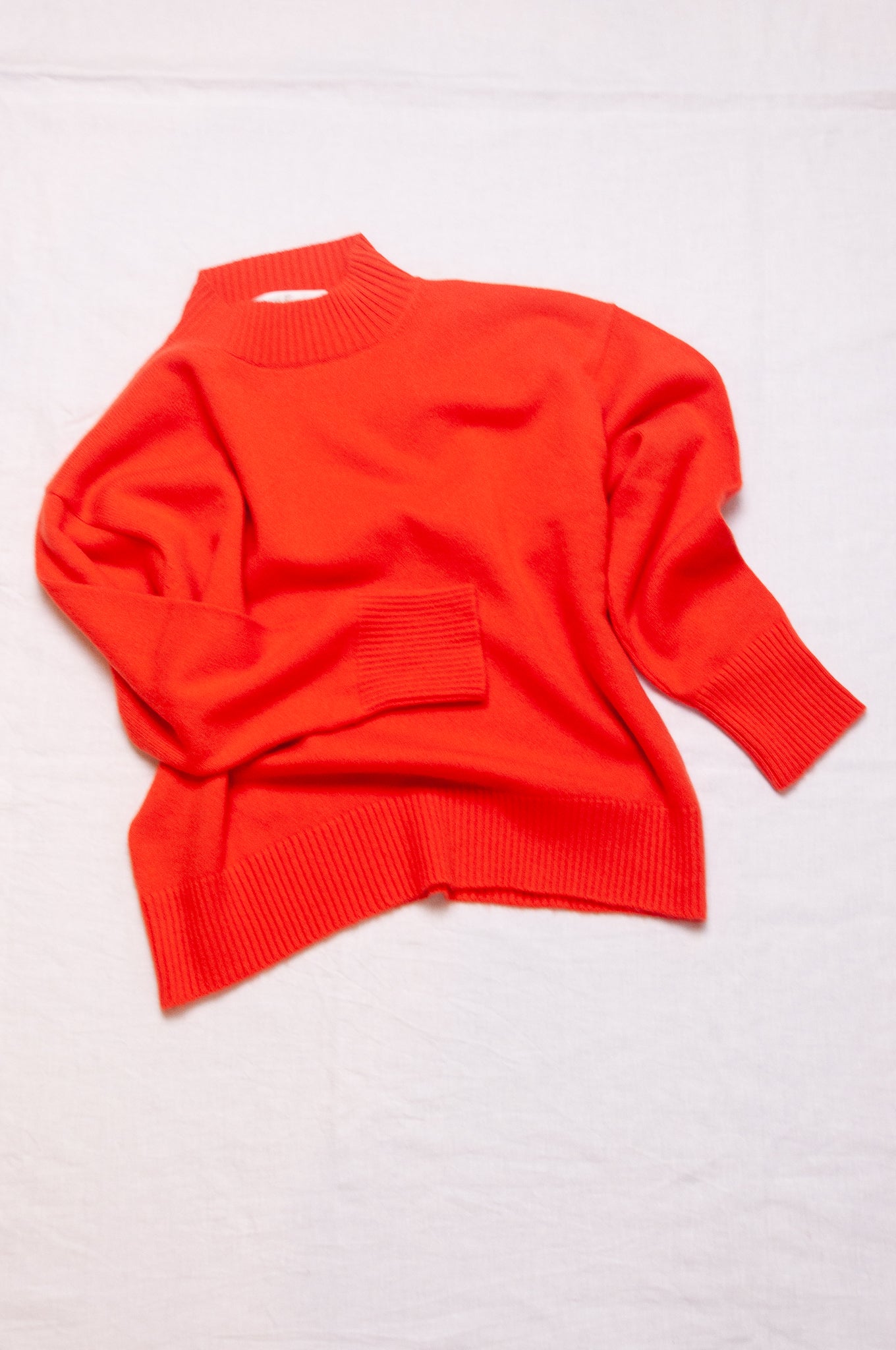 Cashmere turtle neck sweater in tangerine red orange.