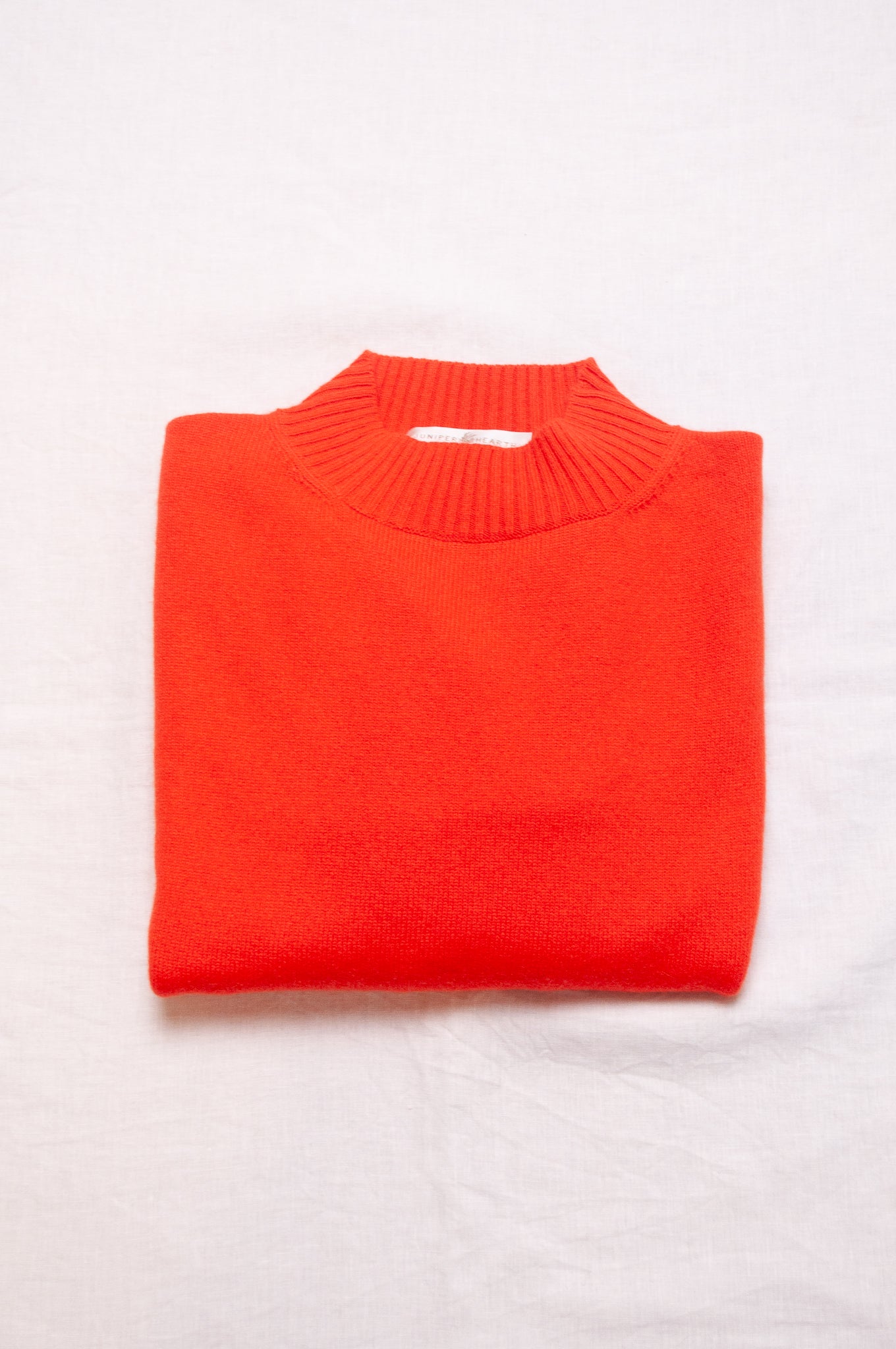 Cashmere turtle neck sweater in tangerine red orange.