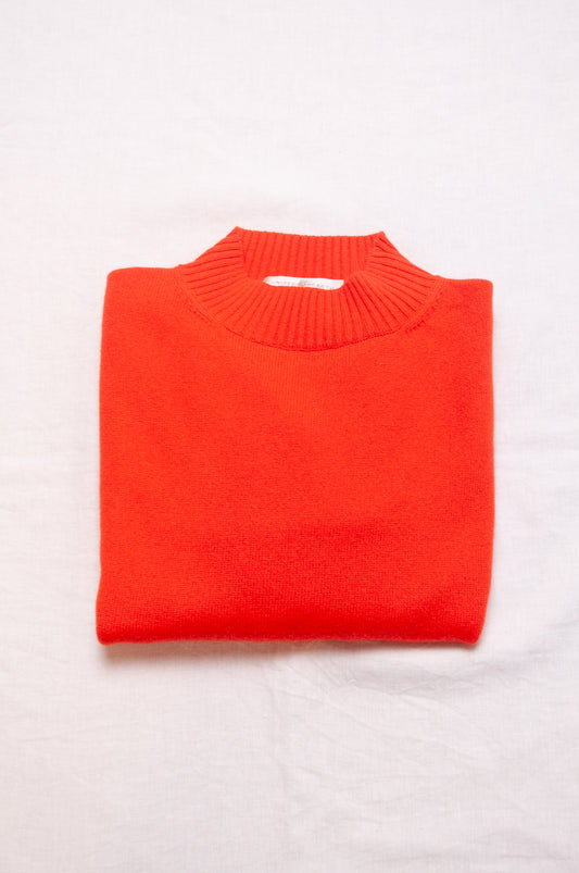 Cashmere turtle neck sweater in tangerine red orange.
