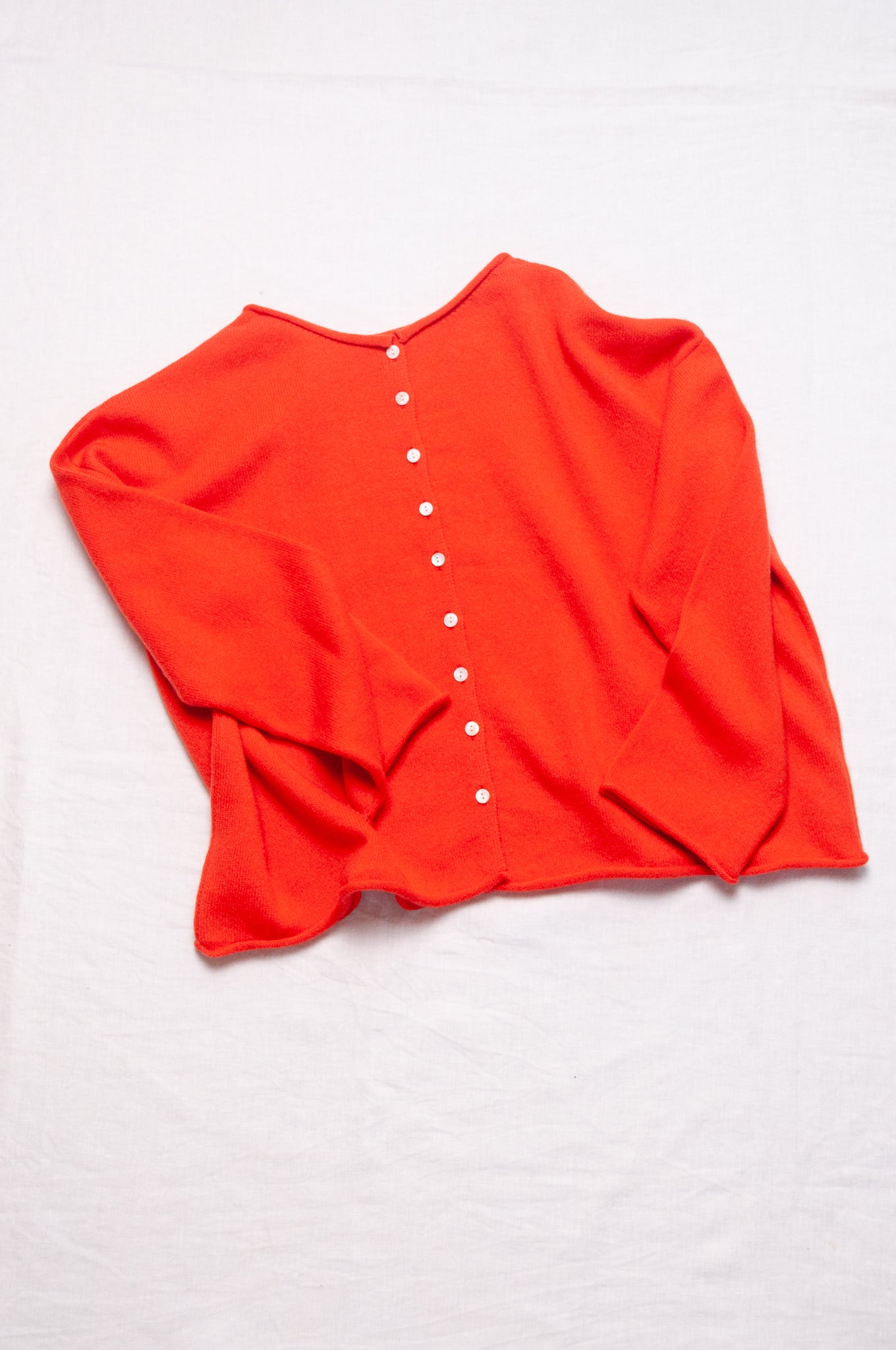One size reversible cashmere cardigan in tangerine red orange.