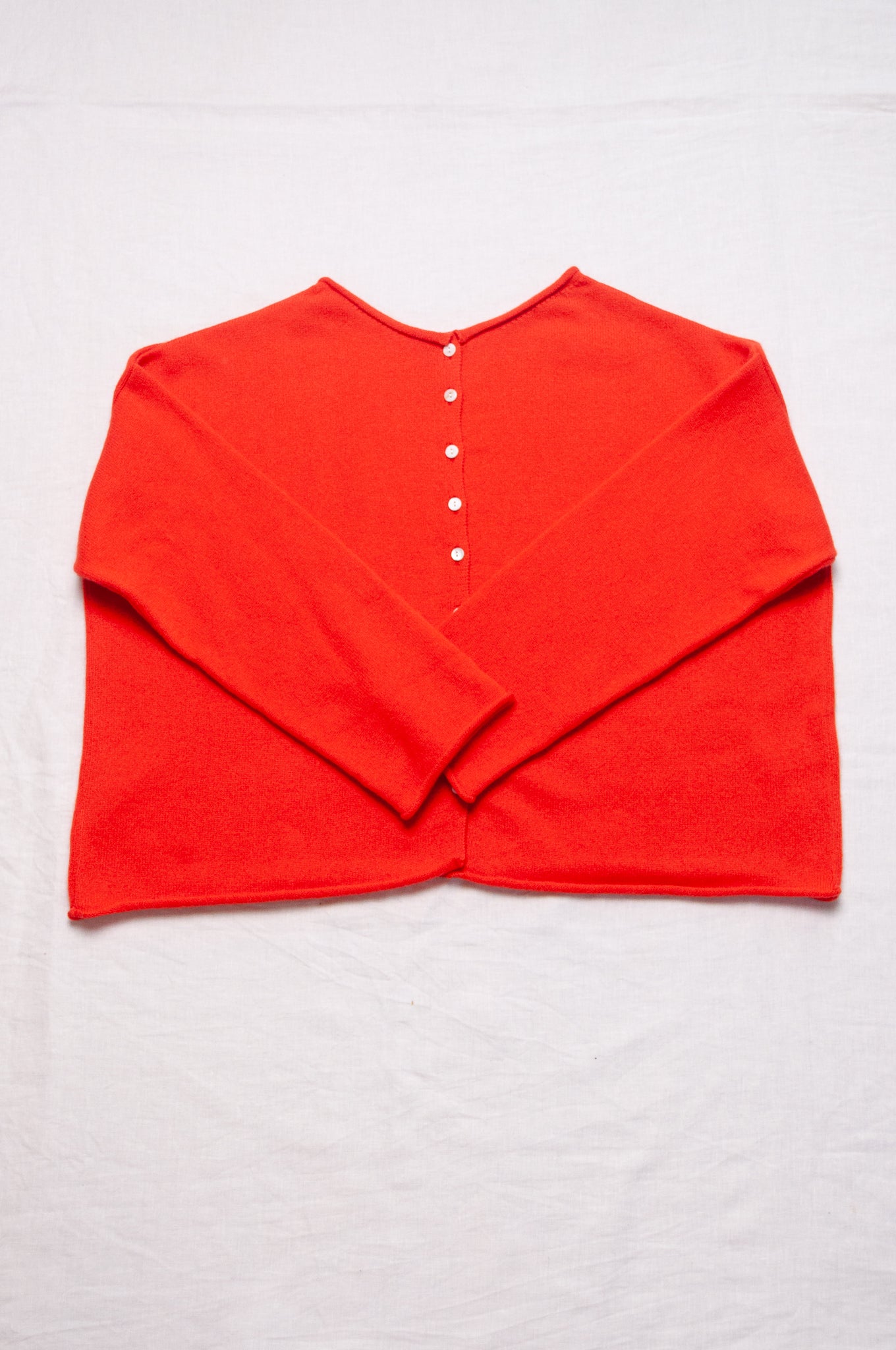 One size reversible cashmere cardigan in tangerine red orange.