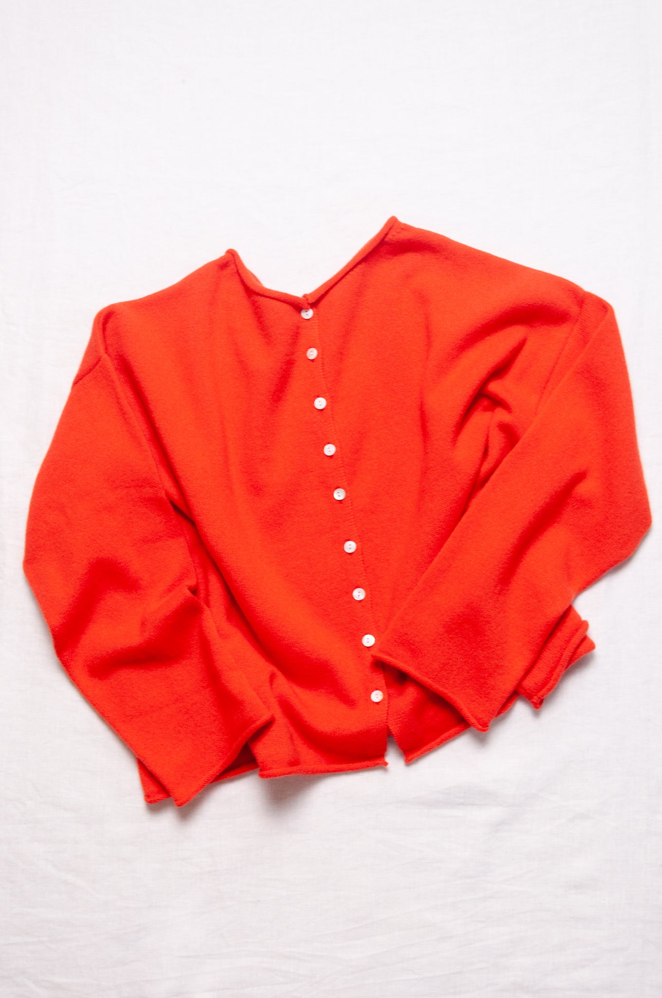 One size reversible cashmere cardigan in tangerine red orange.