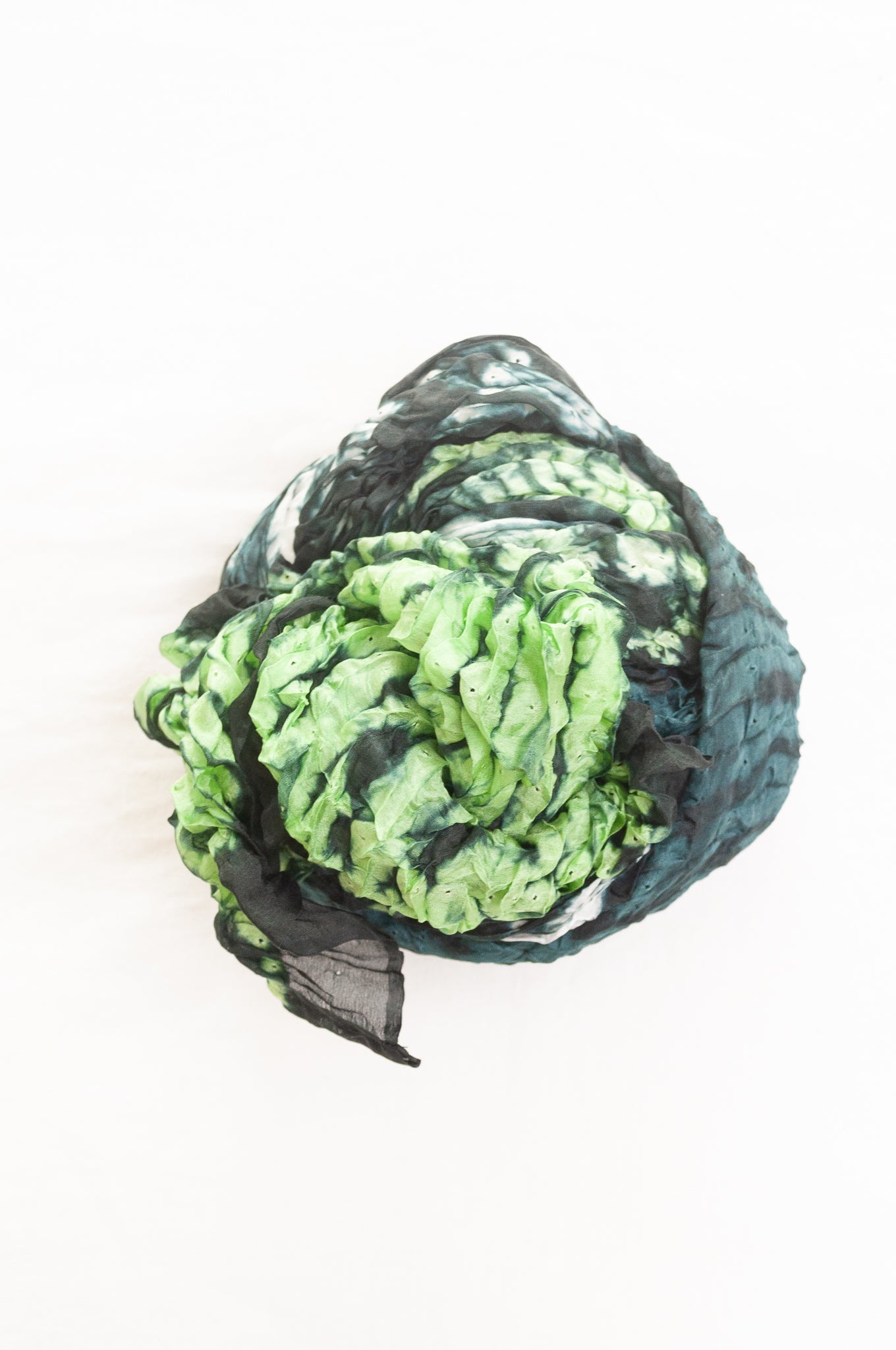Shibori dyed pure silk crinkle finish scarf in shades of green, with stripes of navy and white.