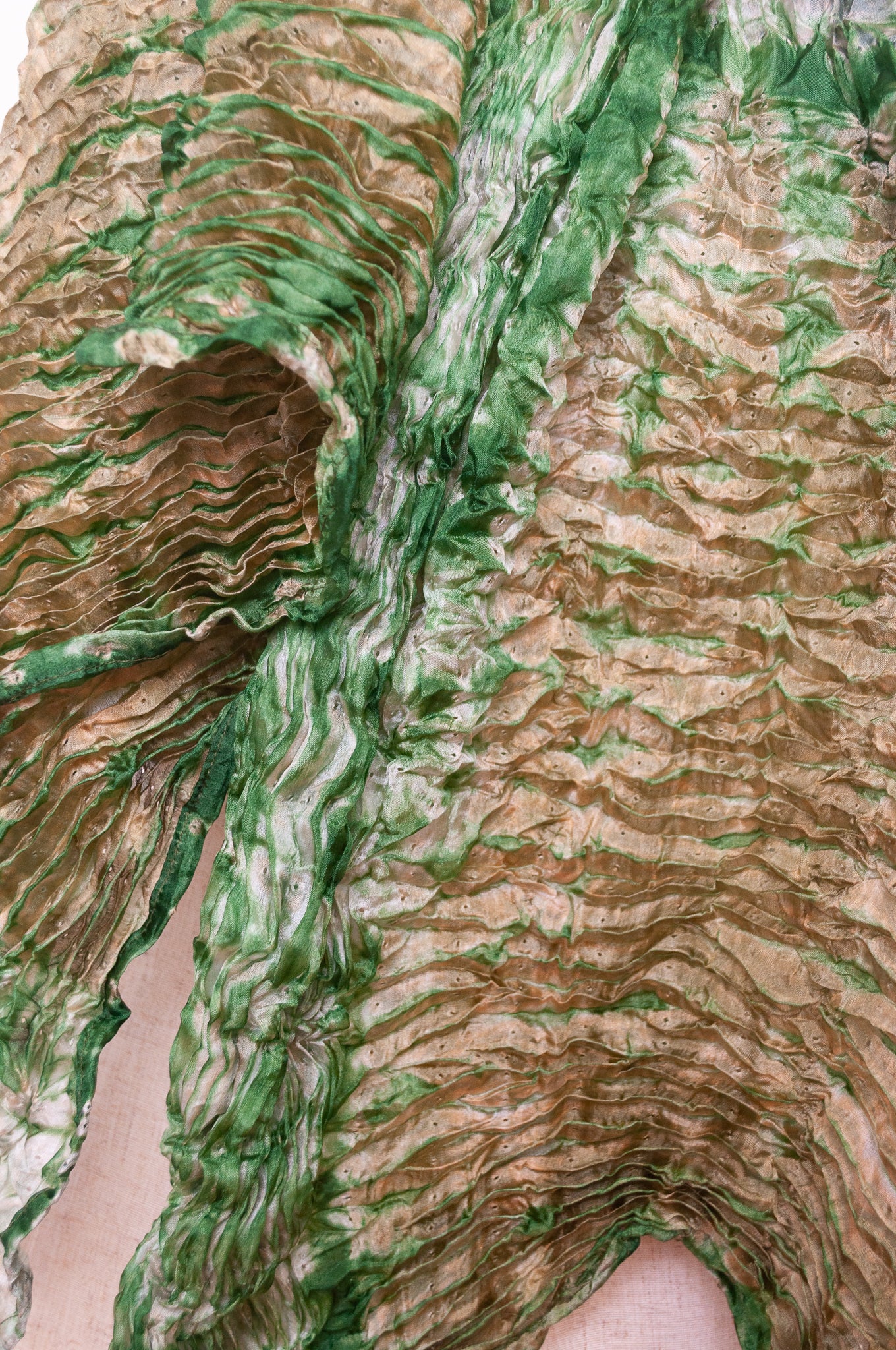 Shibori dyed pure silk crinkle finish scarf in pale bronze and green.