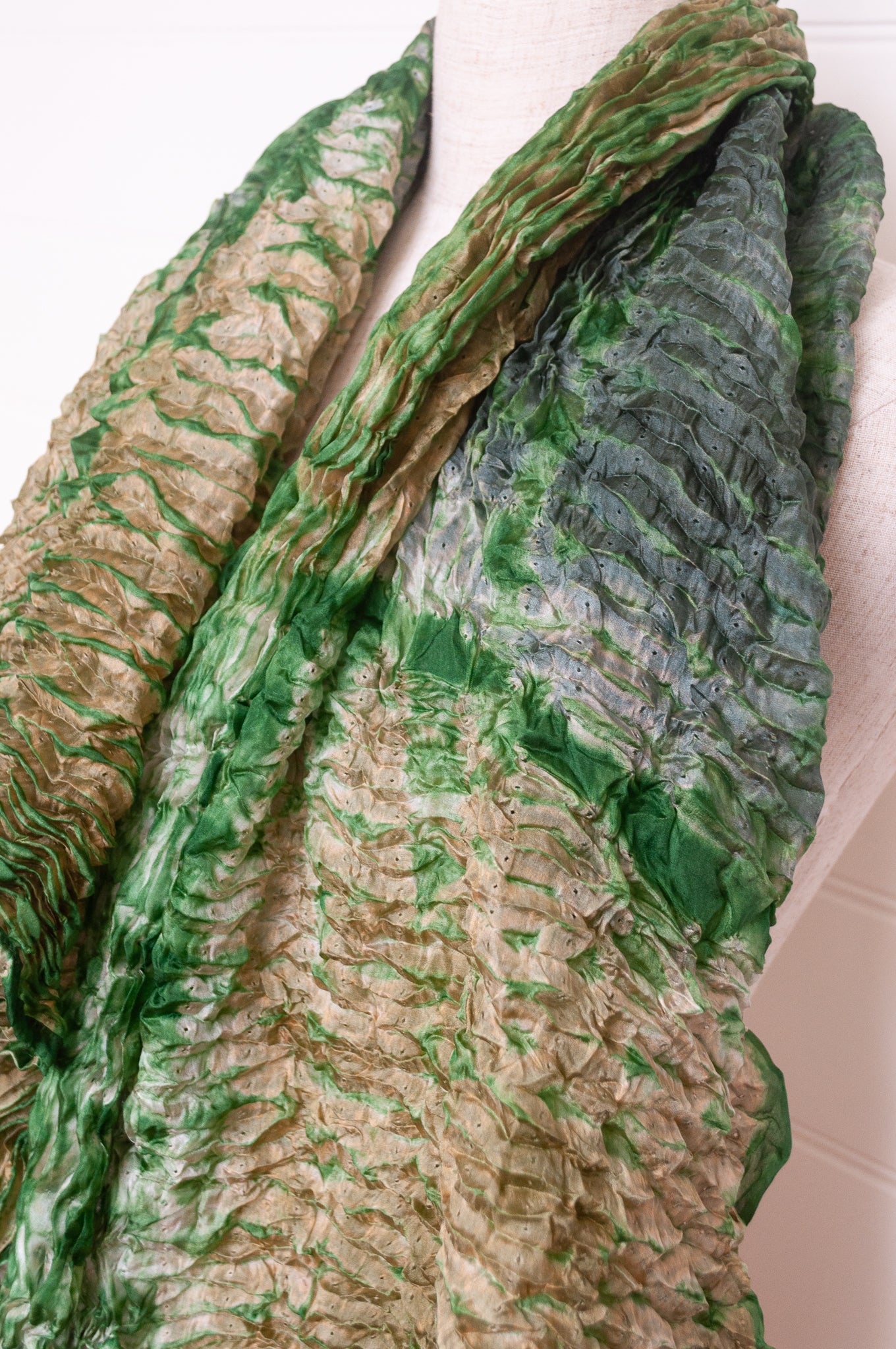 Shibori dyed pure silk crinkle finish scarf in pale bronze and green.