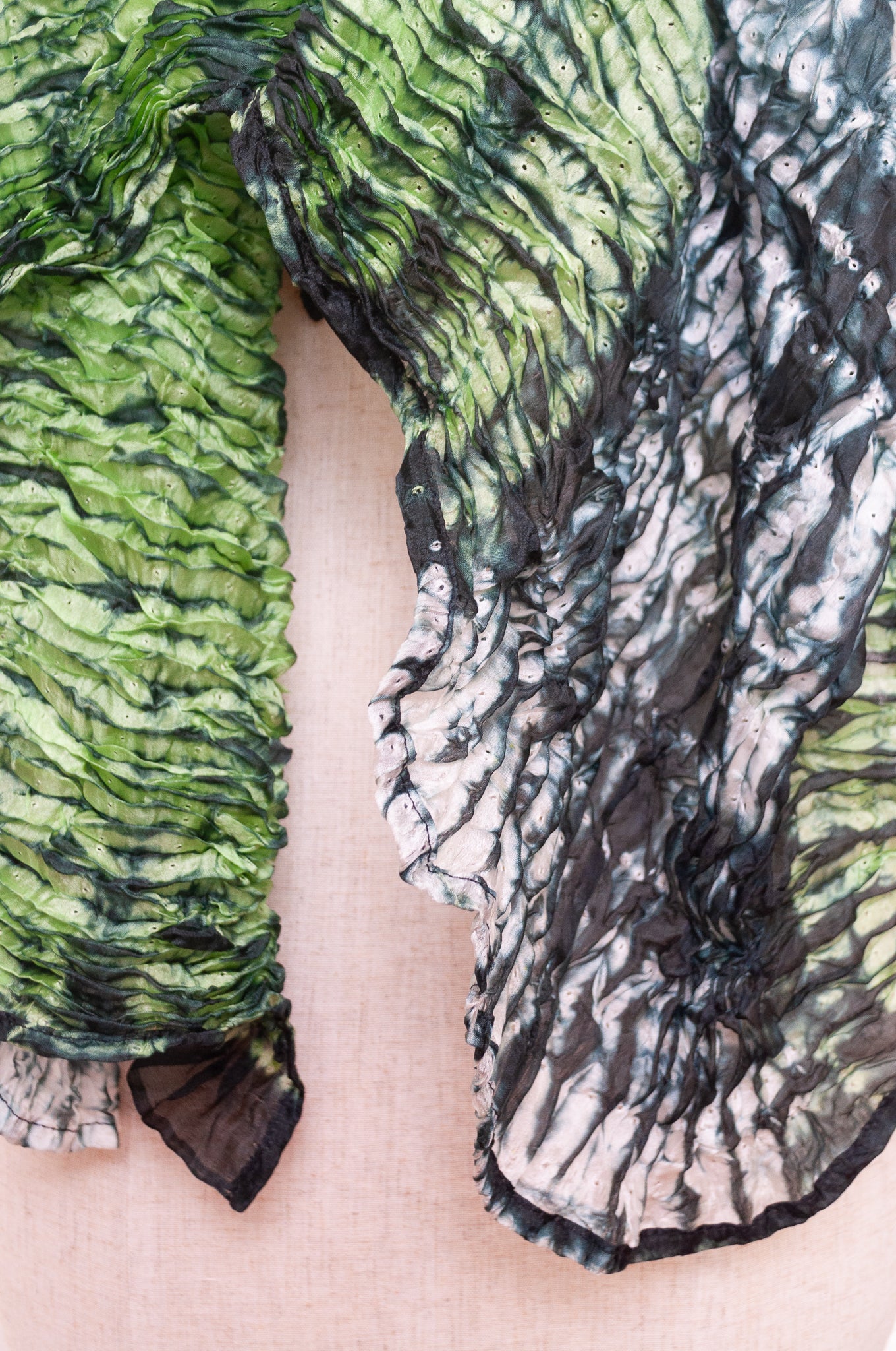 Shibori dyed pure silk crinkle finish scarf in shades of green, with stripes of navy and white.