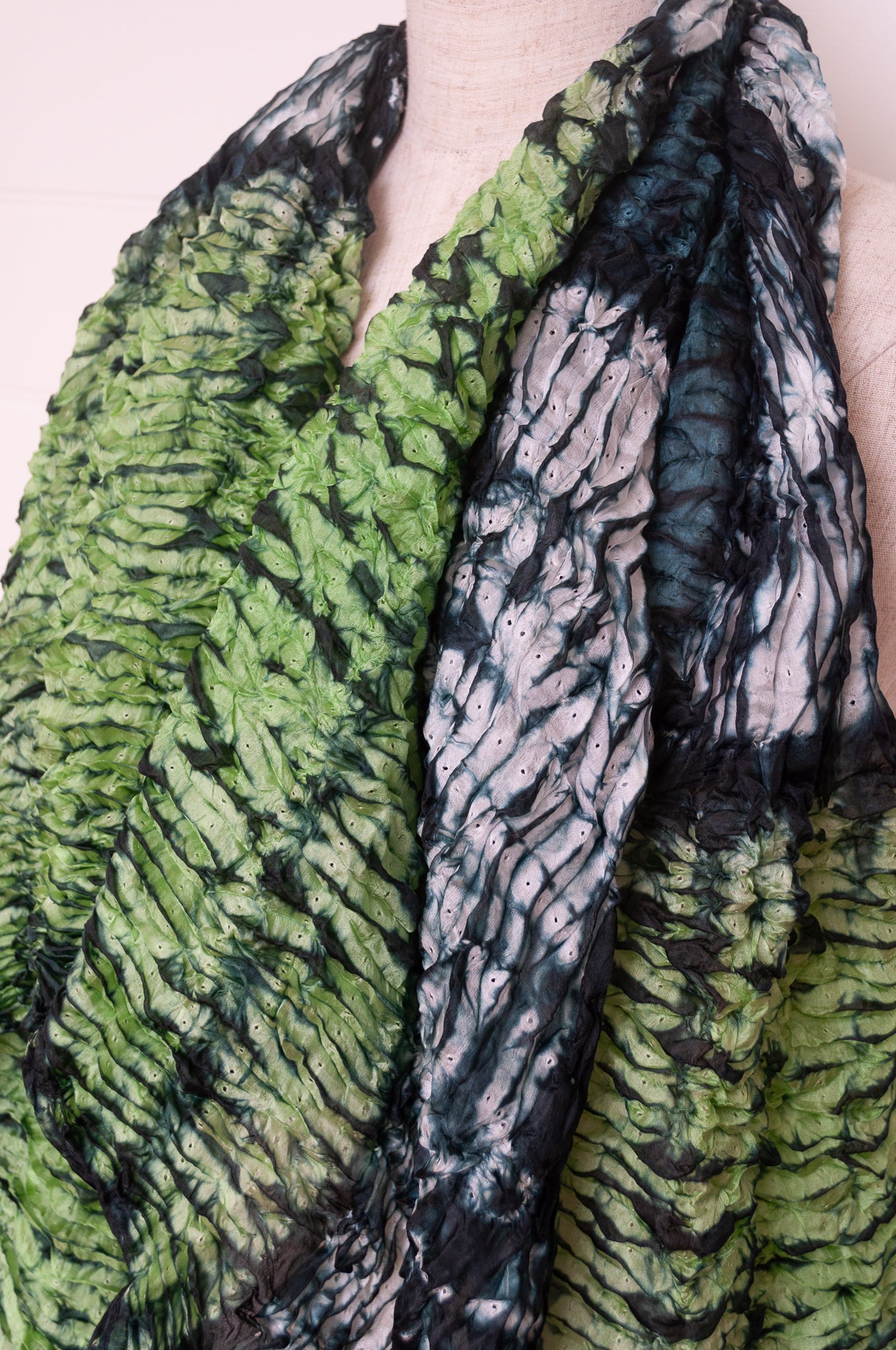 Shibori dyed pure silk crinkle finish scarf in shades of green, with stripes of navy and white.