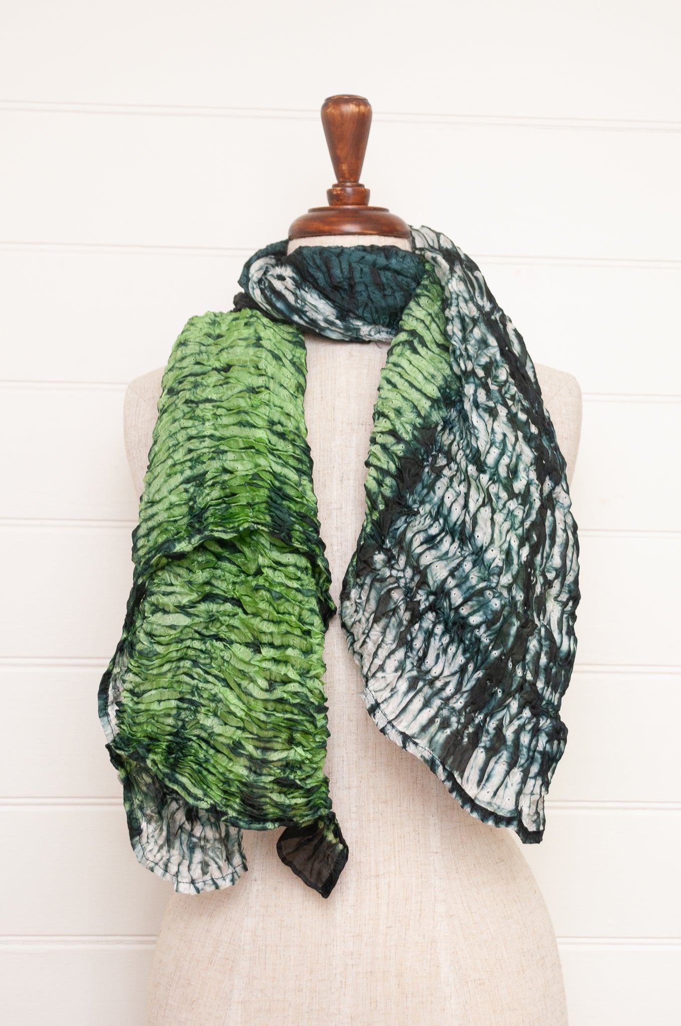 Shibori dyed pure silk crinkle finish scarf in shades of green, with stripes of navy and white.
