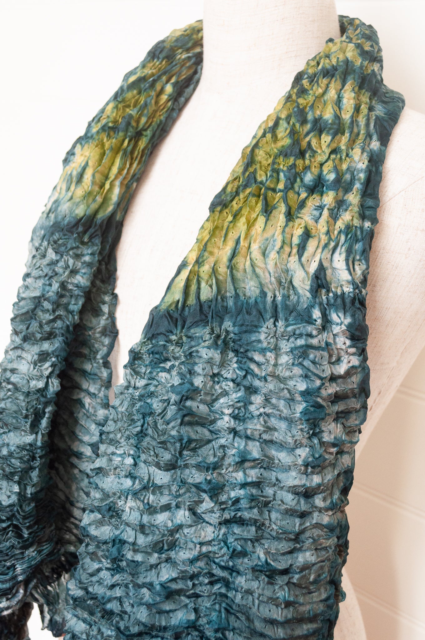 Shibori dyed pure silk crinkle finish scarf in shades of green and blue.