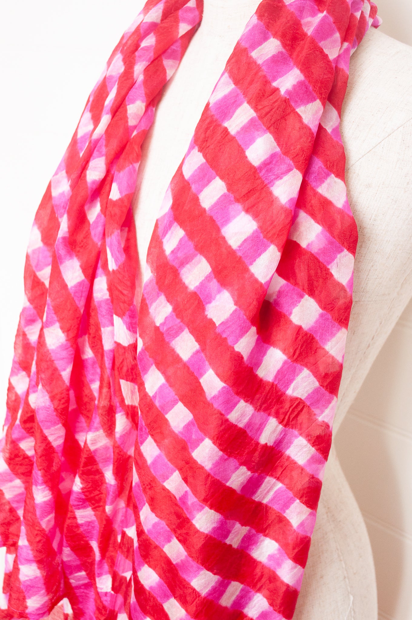 Hand painted pure silk scarf with deep red and pink checks on white.