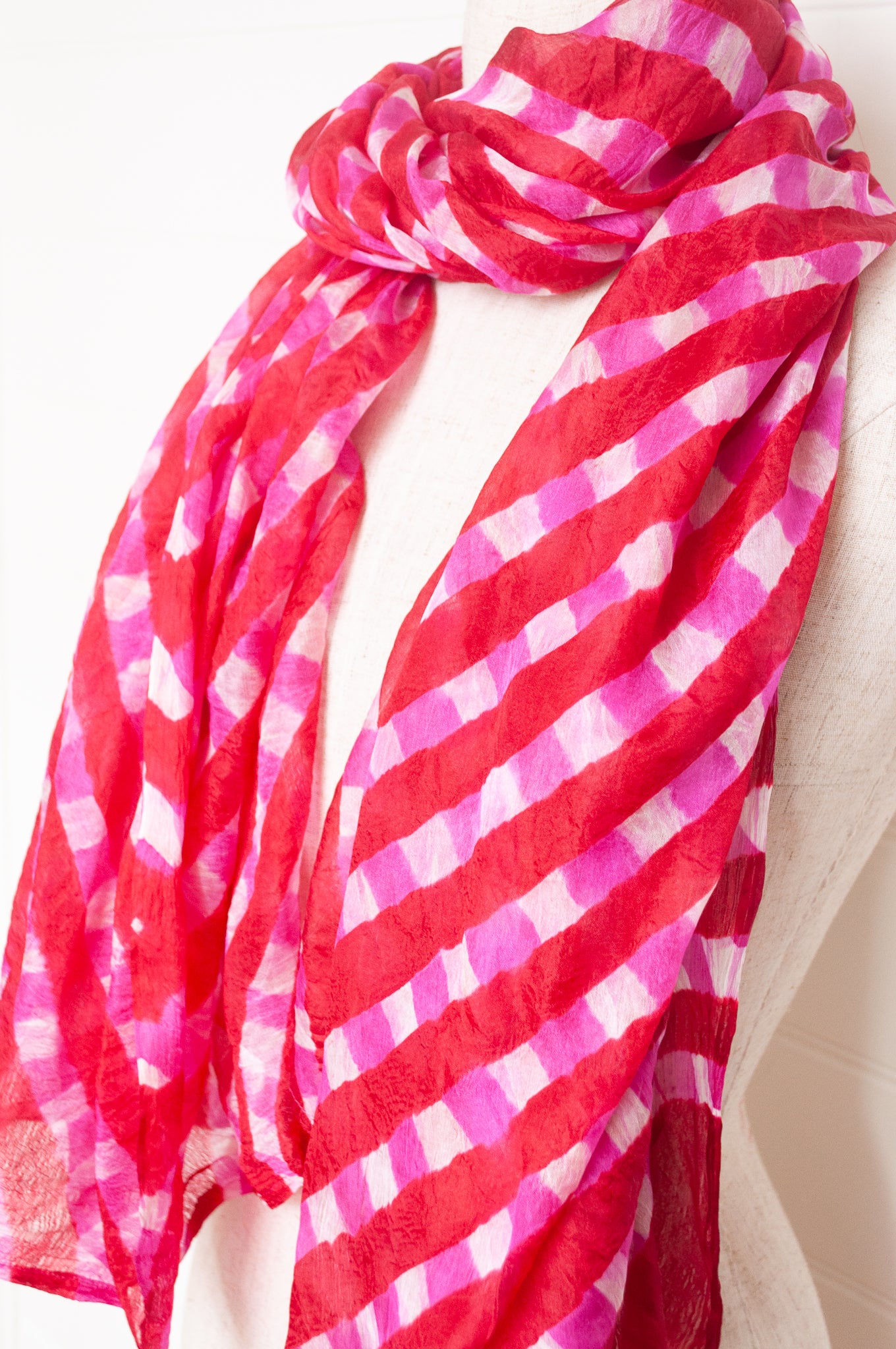 Hand painted pure silk scarf with deep red and pink checks on white.