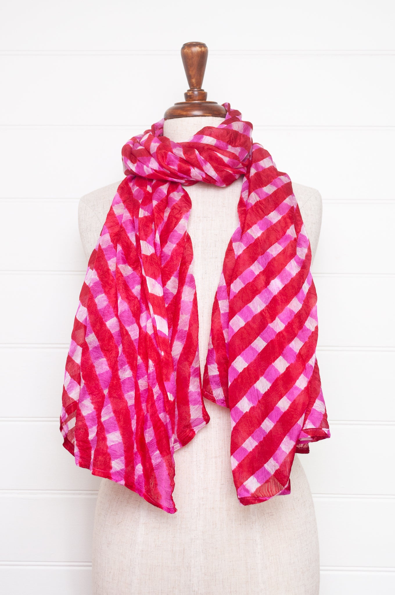Hand painted pure silk scarf with deep red and pink checks on white.
