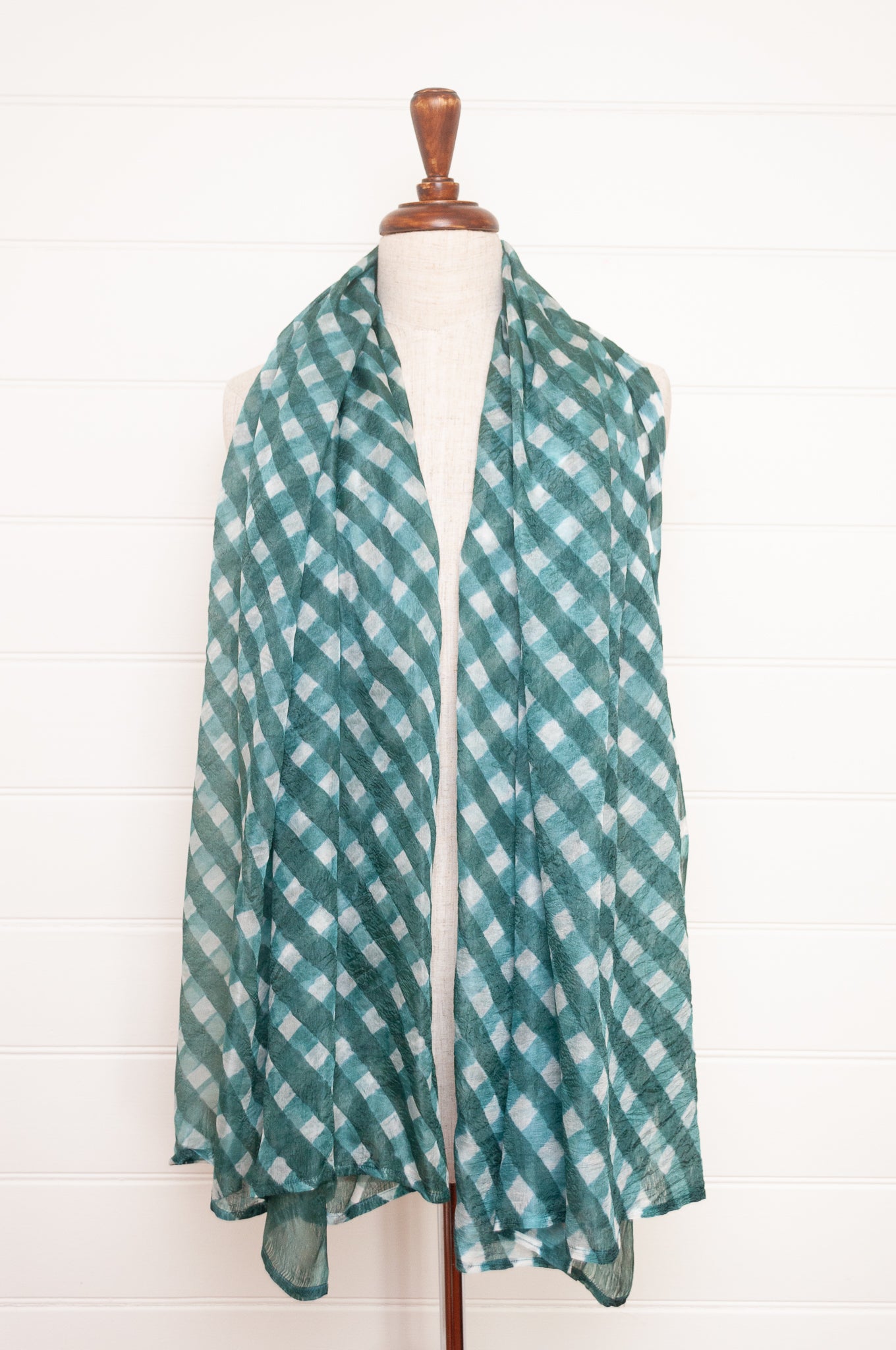 Hand painted pure silk scarf with deep turquoise green checks on white.