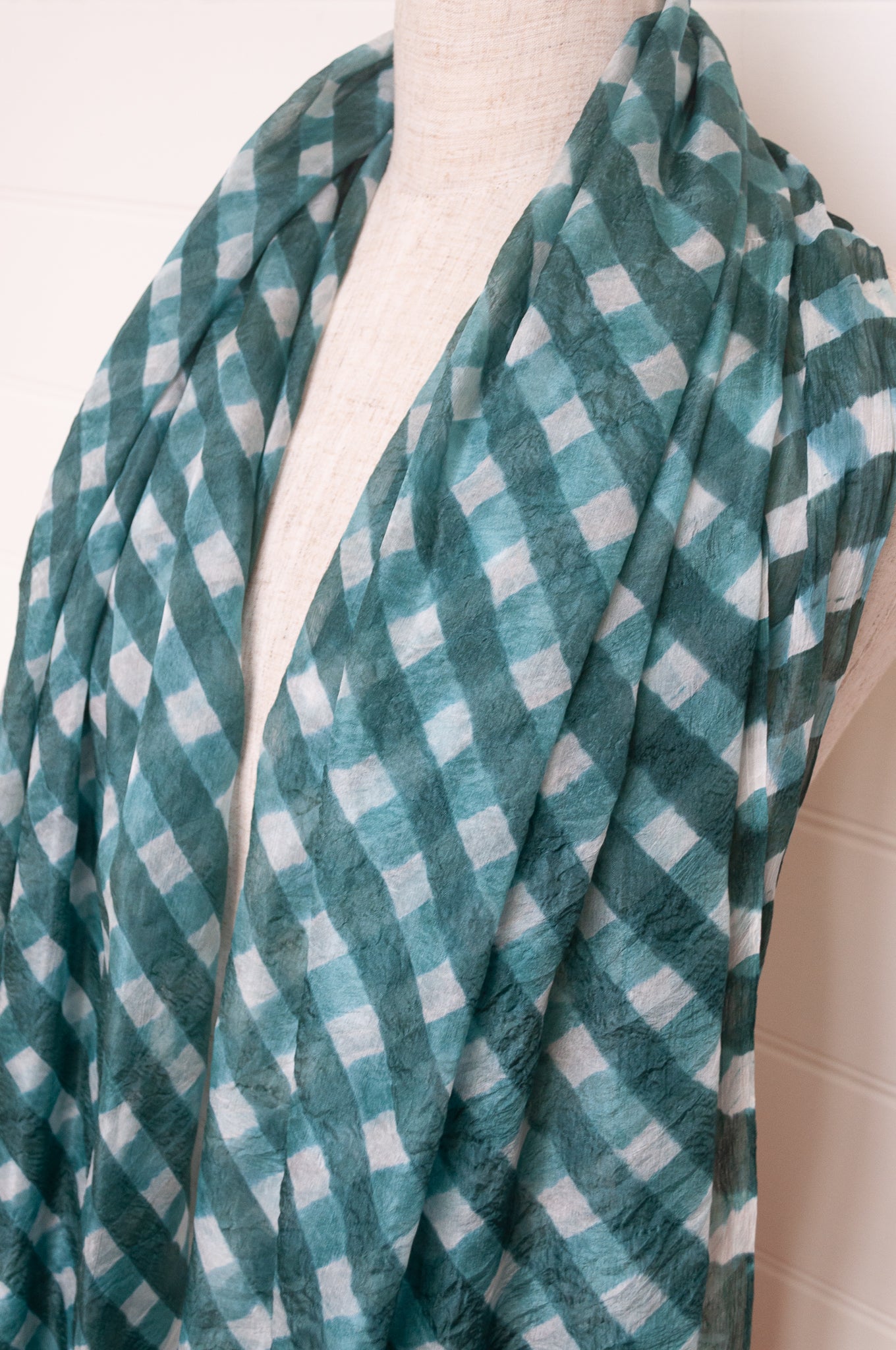Hand painted pure silk scarf with deep turquoise green checks on white.