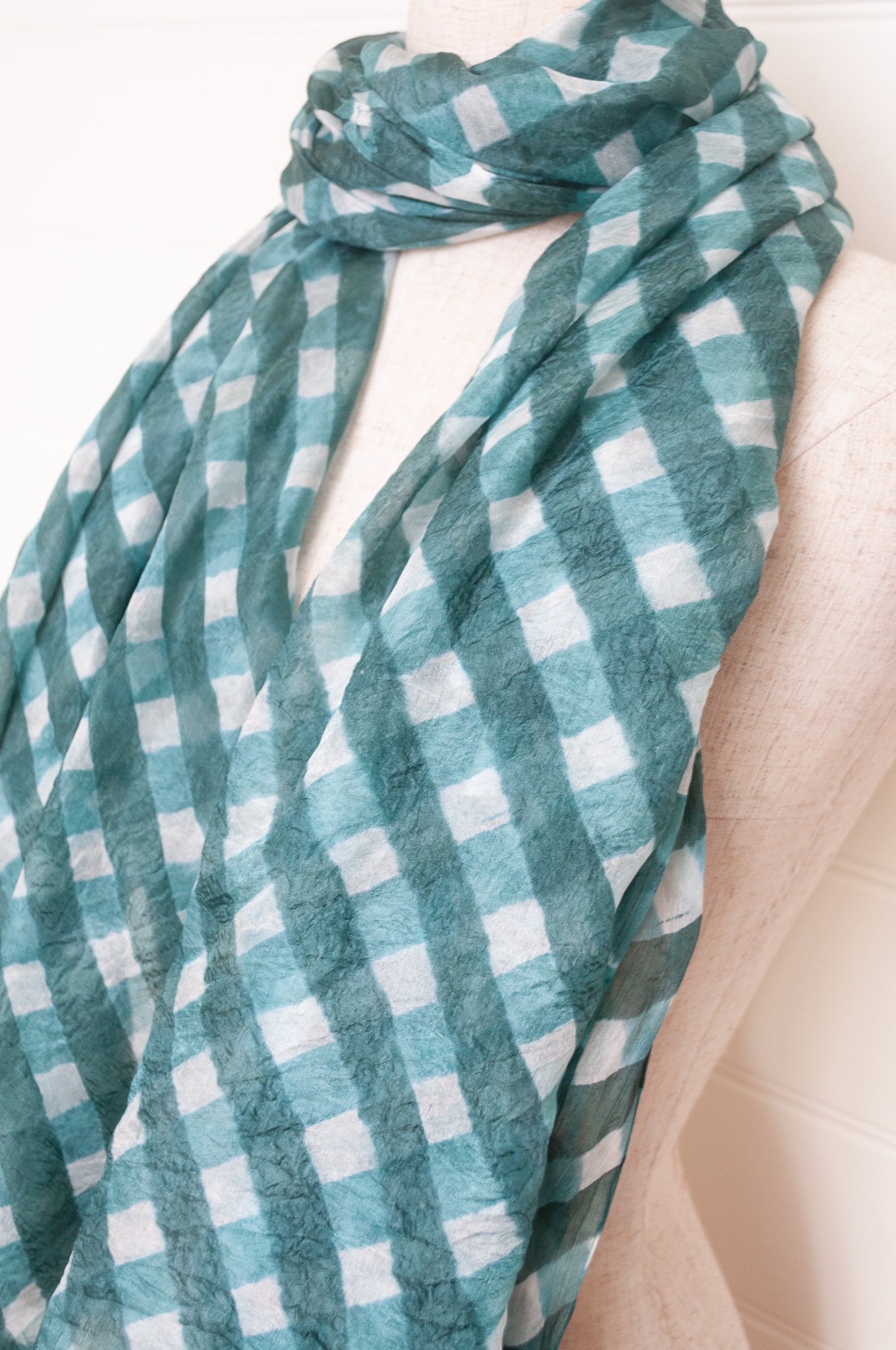 Hand painted pure silk scarf with deep turquoise green checks on white.