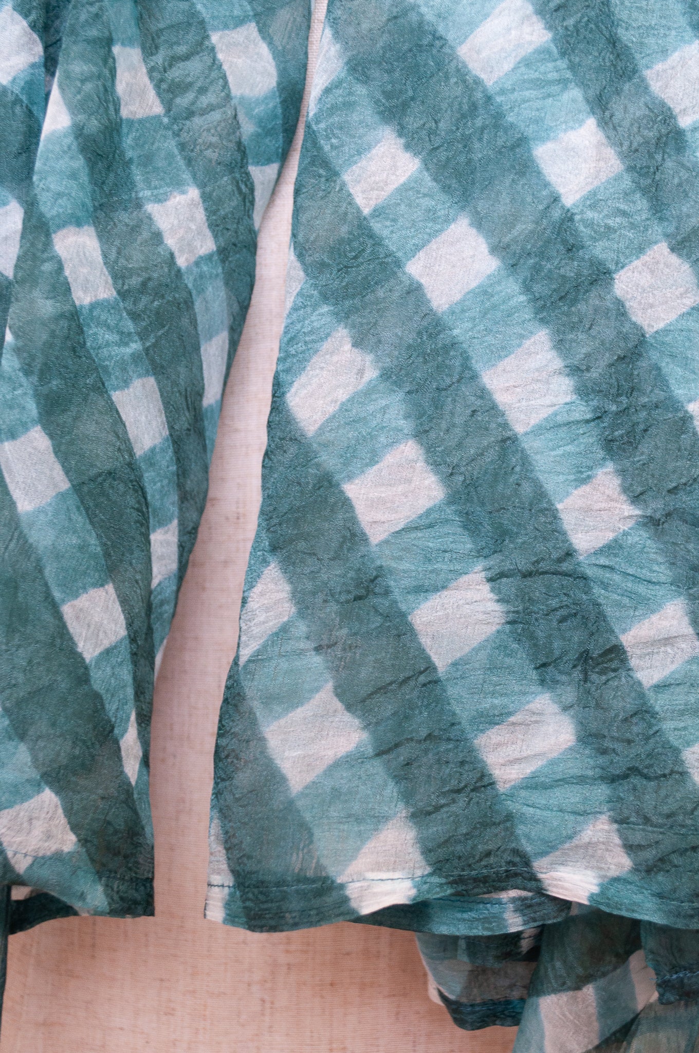 Hand painted pure silk scarf with deep turquoise green checks on white.